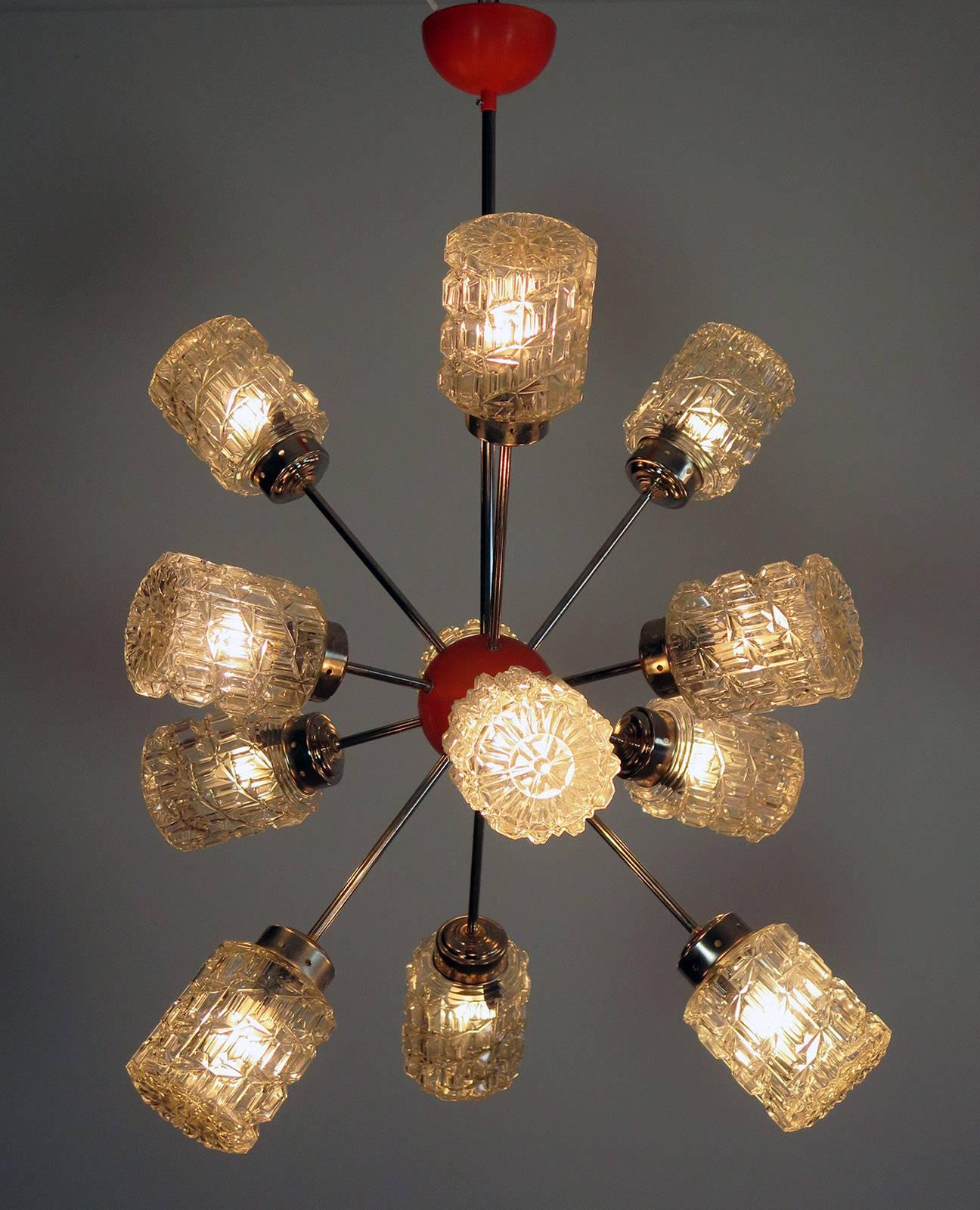Italian sputnik chandelier made by 12 blown glass mounted on a nickel-plated metal frame with a central sphere painted in a classic '70 orange color. It's main feature is the external ashlar shaped diamond tips which creates special light effects.