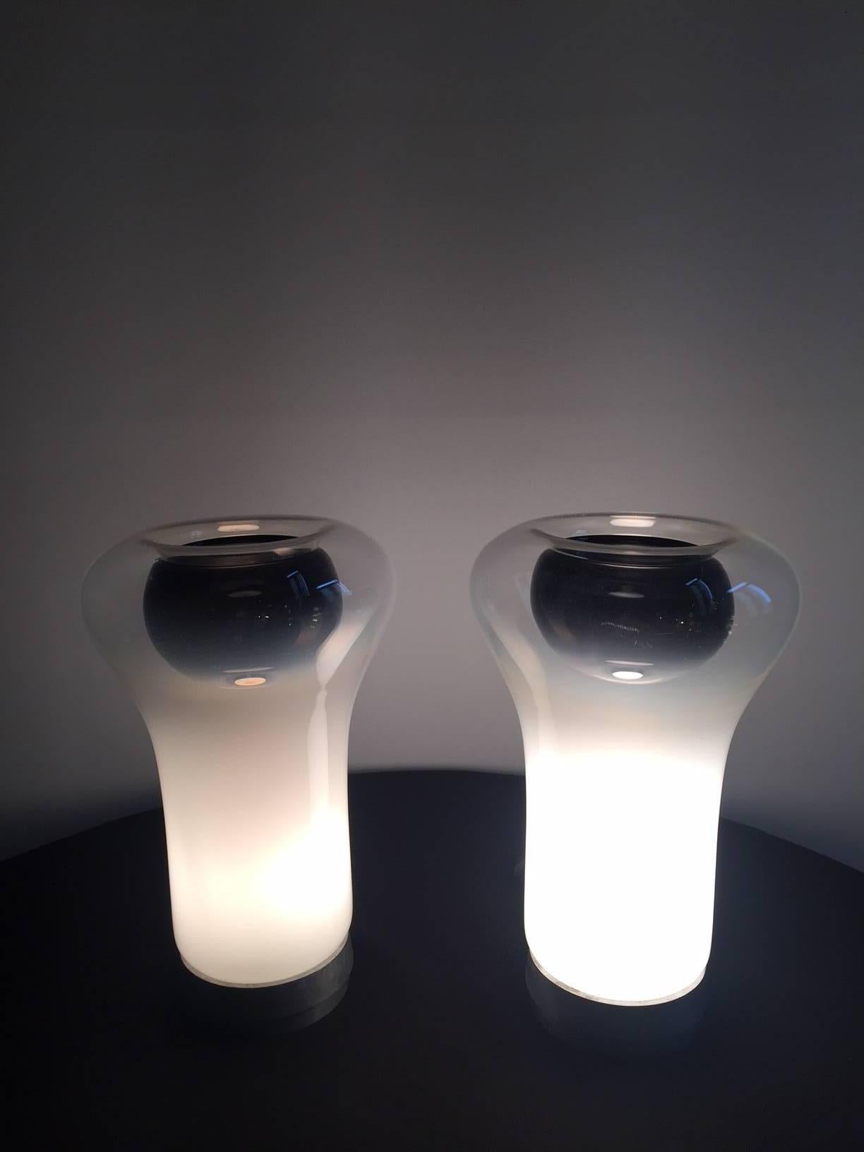 Outstanding pair of the rarest and most beautiful lamps designed by Angelo Mangiarotti for Artemide in 1966, never reissued and for this reason have become collector's items. Metal base and diffuser in white opal blown glass.