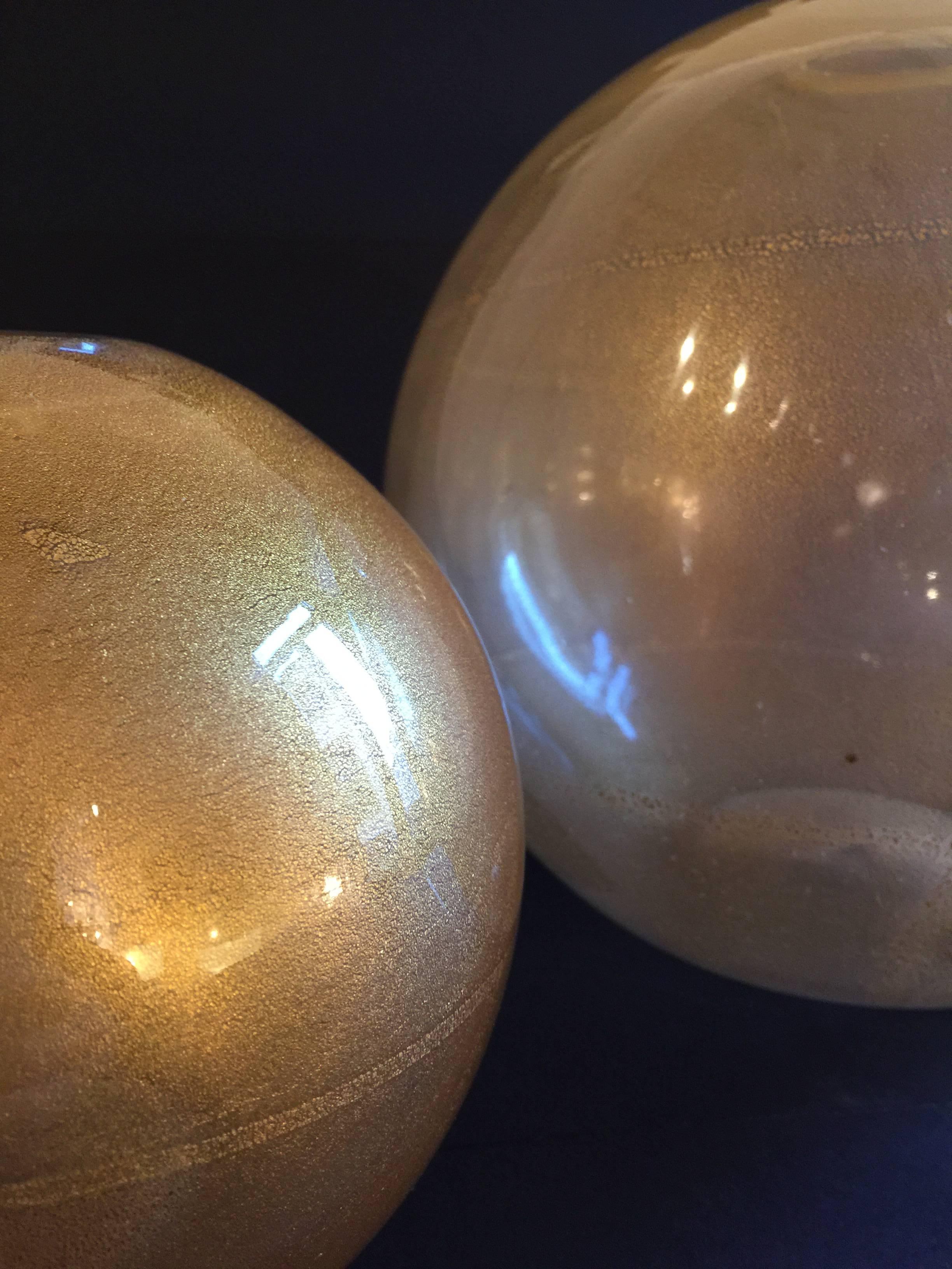 Pair of blown glass in gold leaf vases designed by Carlo Nason for Mazzega in the 1970s. Catalog items S495 and S496. Pristine conditions. Measures: Diameters cm 18 and 28.