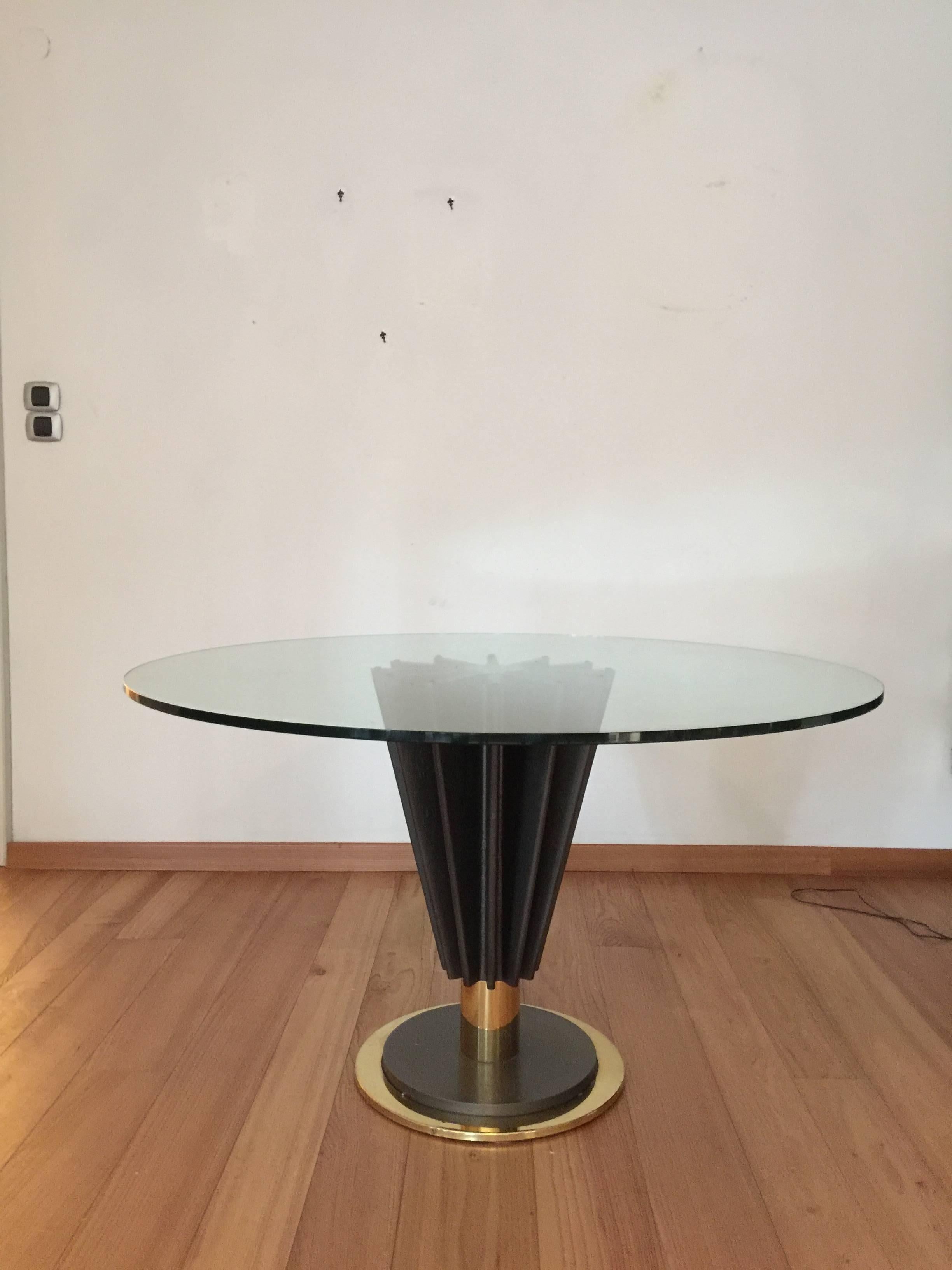 Masterpiece table and chairs designed by Pierre Cardin in the 1970s and hand made in Italy. The table base is made from cast iron and polished brass, the chairs are made form natural and lacquered cherrywood, brass and leather.
Both table and