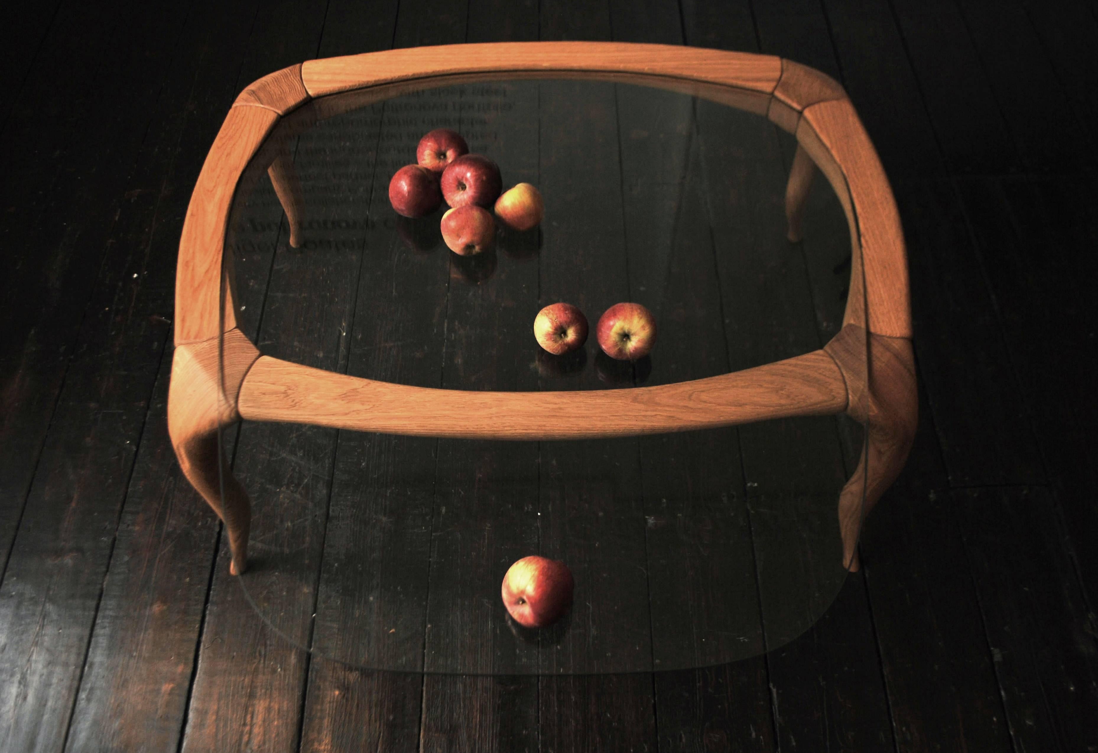 To add an extemporary sense of motion, the structure of this table slopes slightly, though the glass is set at a perfectly horizontal angle 

Frame in carved, sandblasted English oak. Top in tempered glass.