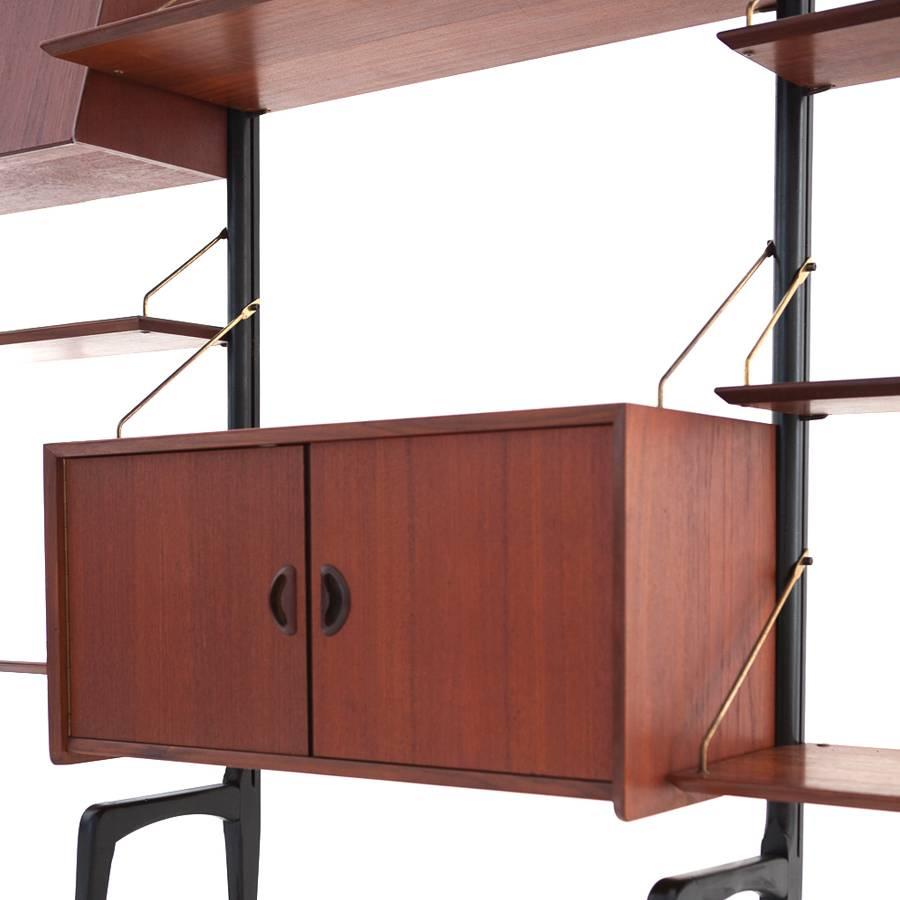 A beautiful cabinet unit designed by Louis Van Teeffelen, manufactured by WéBé in The Netherlands, circa 1950.
The Unit is made of wood with the base made of black lacquered wood and the arms made of brass. The handles and shape of the feet reveal