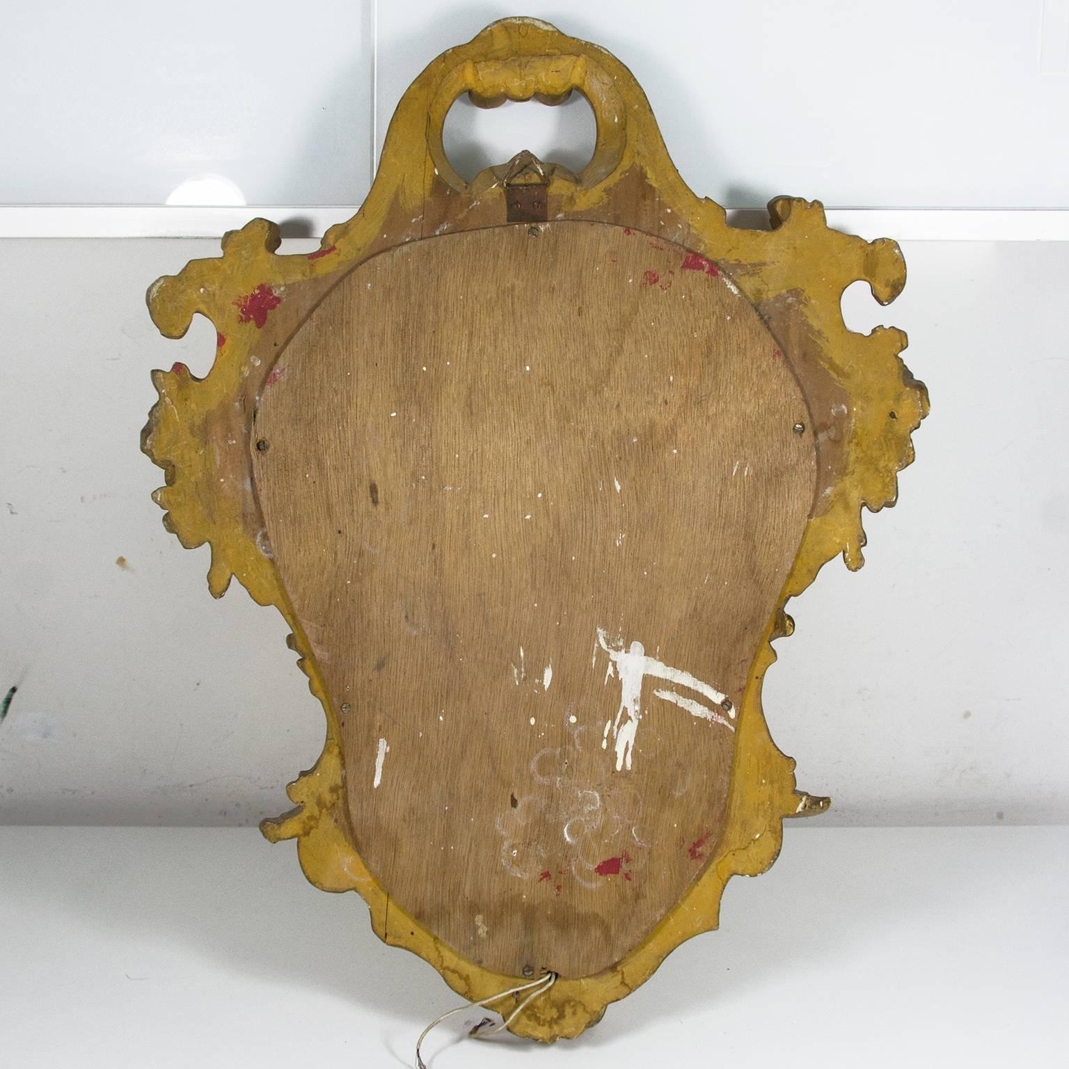 Antique Italian carved giltwood ornate wall mirror with lamp scones. Very good original condition (please see photos). Measurements: Height: 52 cm / 20.5 inch, width (the widest part): 40 cm/15.7 inch.