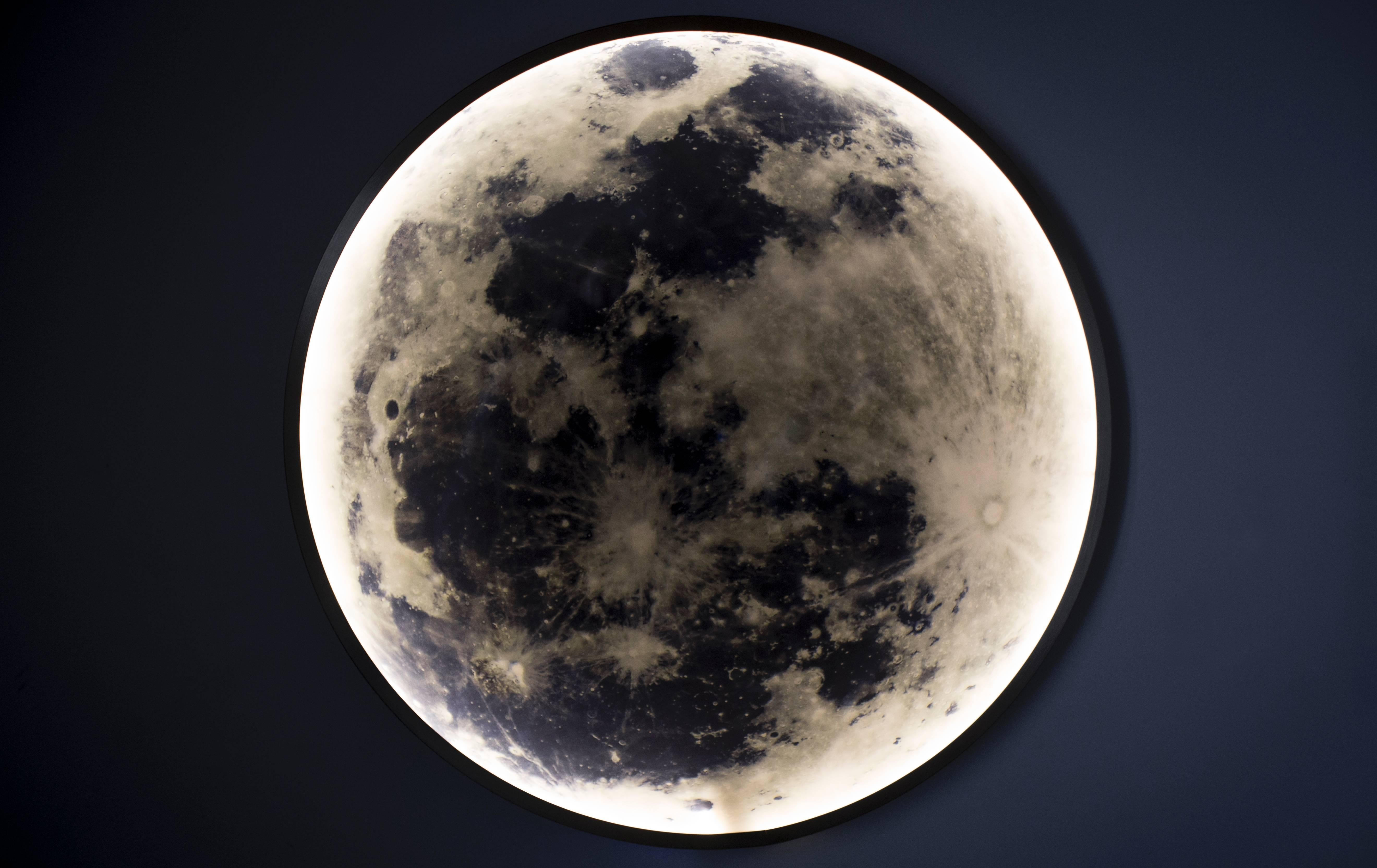 Das in massiver Bronze oder Stahl gerahmte Bild des Mondes wird von innen beleuchtet und von Glas umschlossen, so dass ein Werk entsteht, das als Licht, Skulptur und Bild zusammenhängt. Das Moon Light bietet dimmbares Umgebungslicht in einer