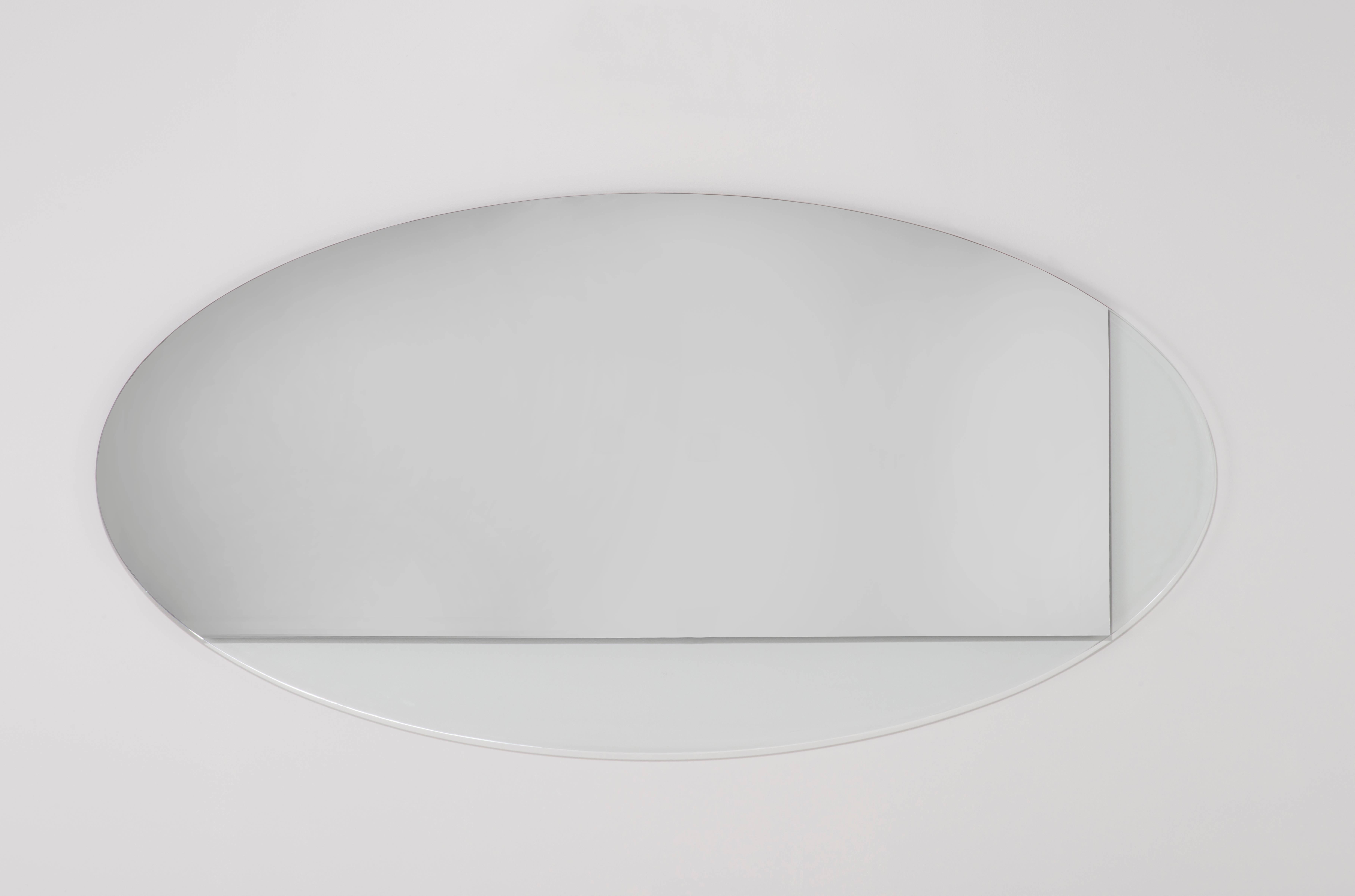 The Ida Oval is a large-scale oval mirror that partners mirror with translucent glass, creating unexpected layers of light and reflection. The scale of this mirror makes for a perfect addition above a large piece of furniture, to extend the visual