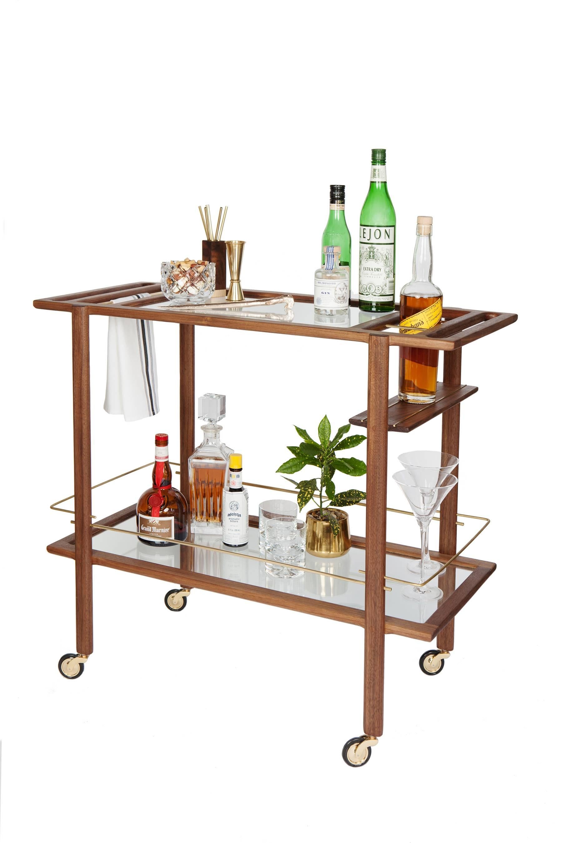 Solid wood constructed barcart with hand-cut joinery, tempered glass panels, and fine metal accents. Handmade in Los Angeles, California.

Shown in walnut.
Please inquire for custom wood, metal and glass options.

Wood type is available in