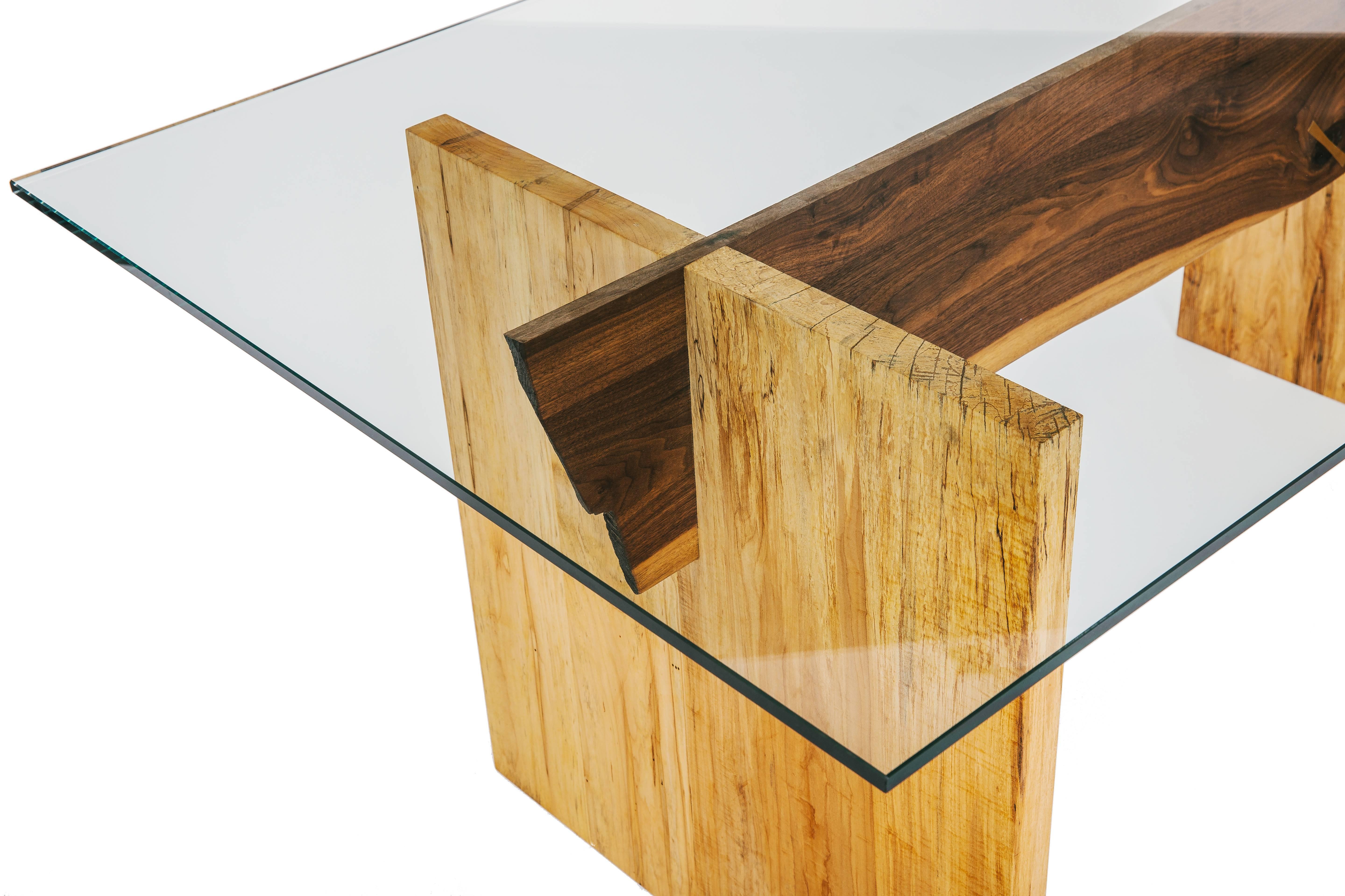 Double slab dining table base with intersecting solid wood stretcher. True brass Dutchman joint. Polished tempered flat polished glass top. Handcrafted in Los Angeles, California.

Wood base is customizable with options of ebonized oak, white oak,