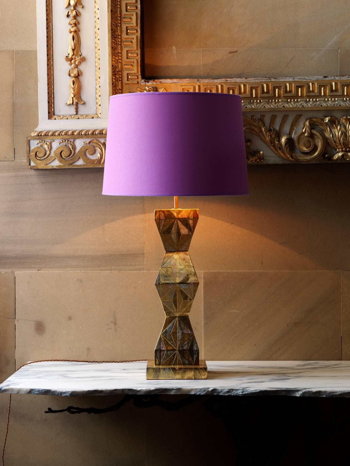 The lamp is cast in Jesmonite, then gessoed, the pattern of clay colors and watercolors is applied before it to is water gilded with 23-carat gold leaf. Fittings and lamp holder dark brass with old gold colored silk covered flex.