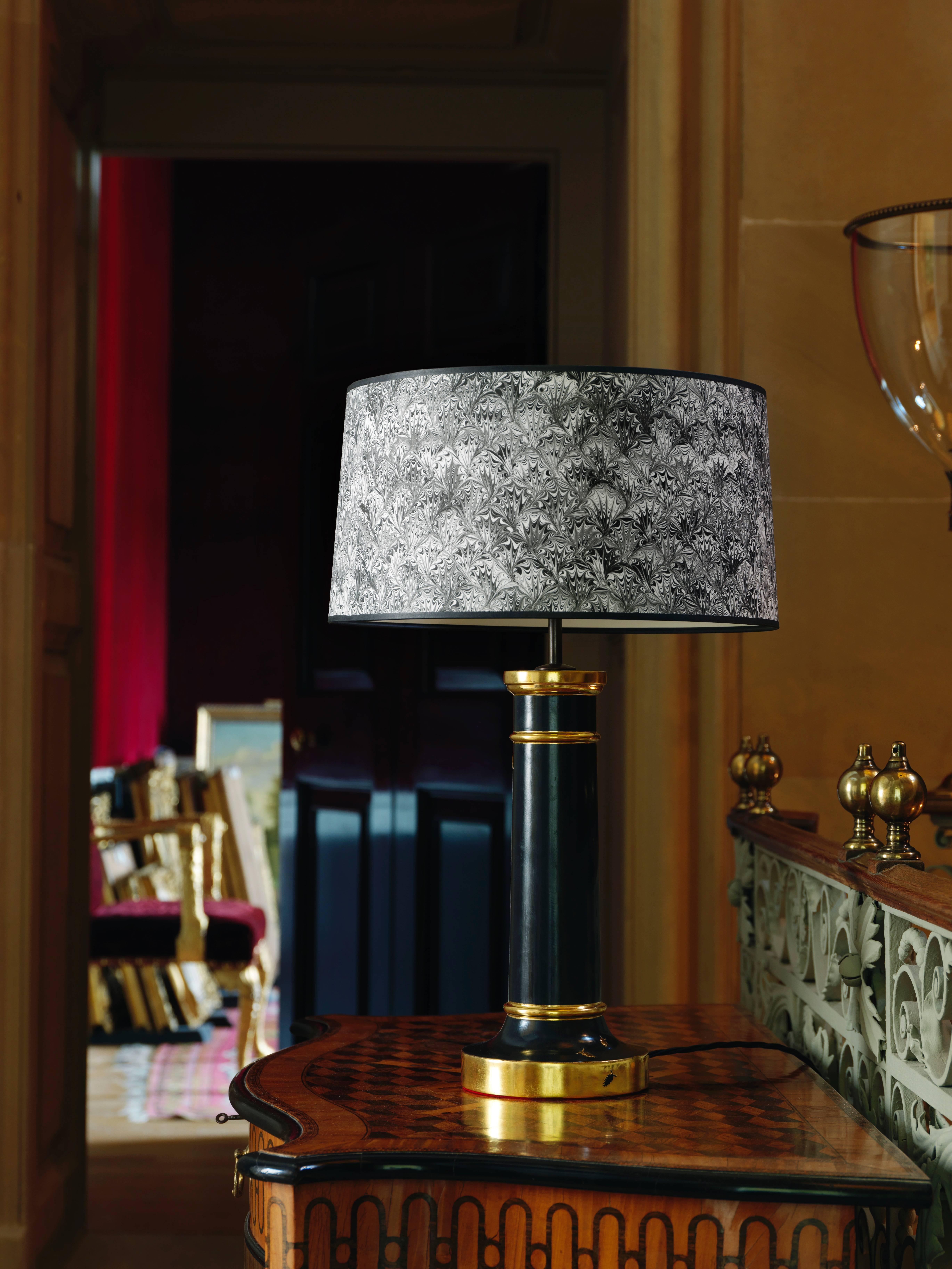 The lamp base is gessoed with gilded hand drawn raised gesso woodlice detail in 23.5-carat gold leaf and burnished gunmetal grey clay. The fittings are dark brass with black silk covered flex.