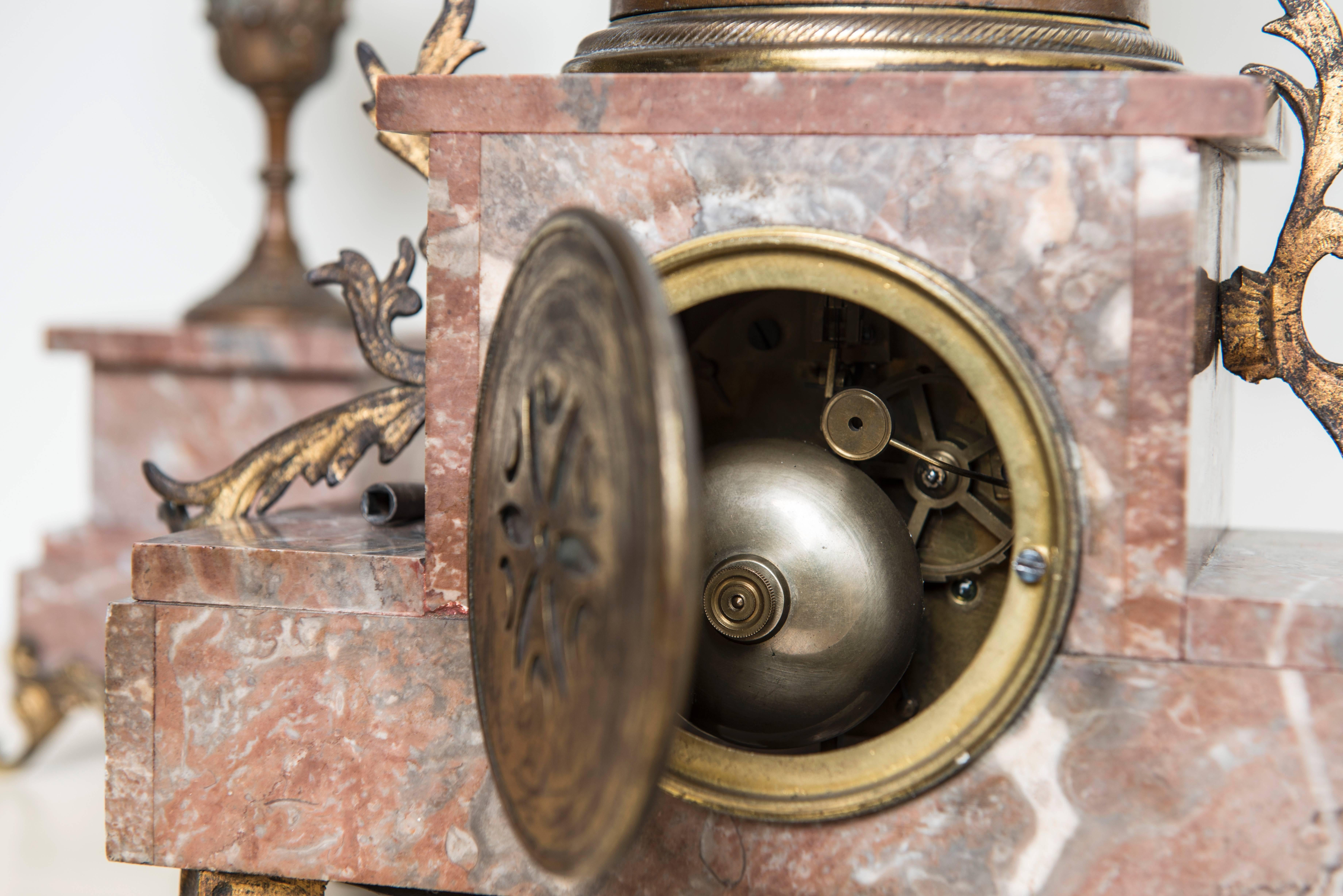 Marble Art Nouveau clock with bronze women.
A French antique late 19th century bronze figural rouge marble. The clock is working, including a key. Signed on the back and label in the front. 
A beautiful pink marble style Art Nouveau.
Other two