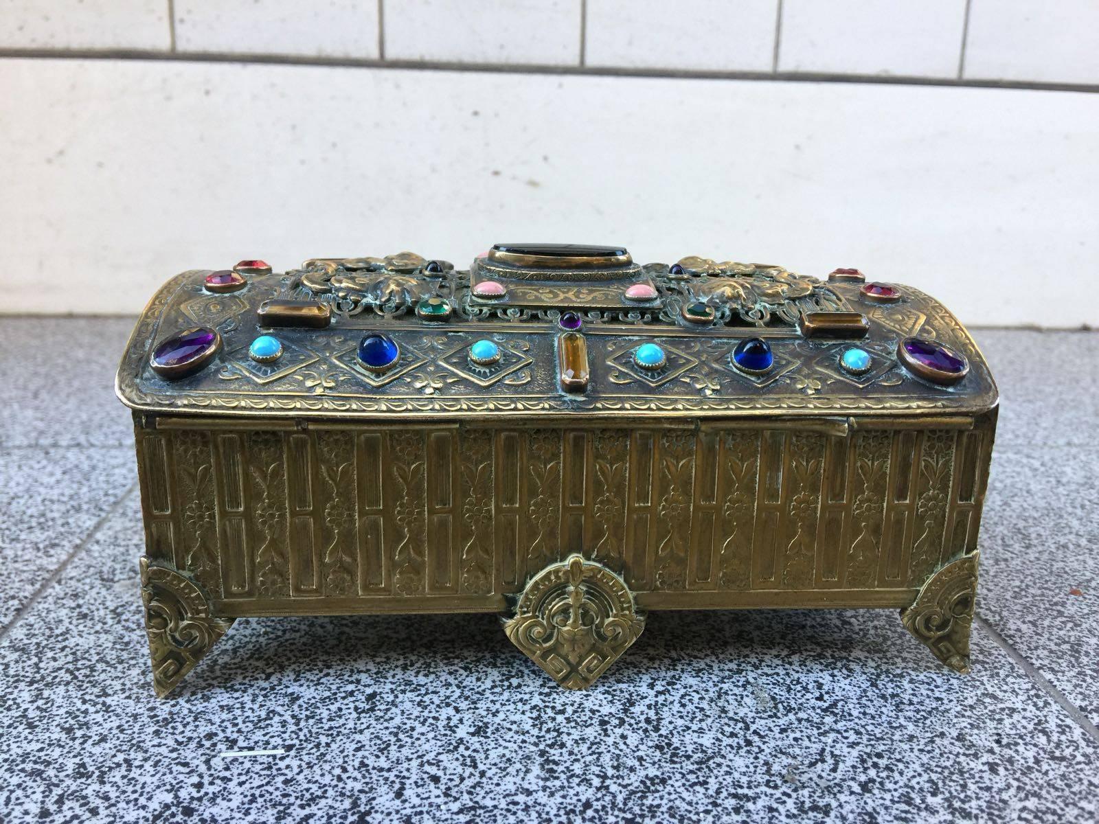 An exceptional 19th century brass box from Paris with large onyx in the middle, citrine, coral, garnets, turquoise, sapphires and green garnets.
