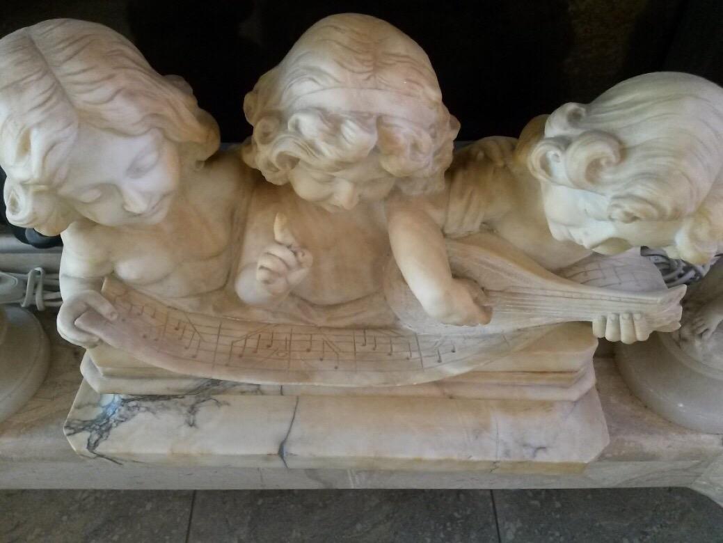 A fine sculpture made in marble
Signed by an Italian master Adolpho Cipriani (Italian, 1880-1930)

The figure is a constellation of three young children with angelic faces staring at the note and giving the feeling that we can hear their copper