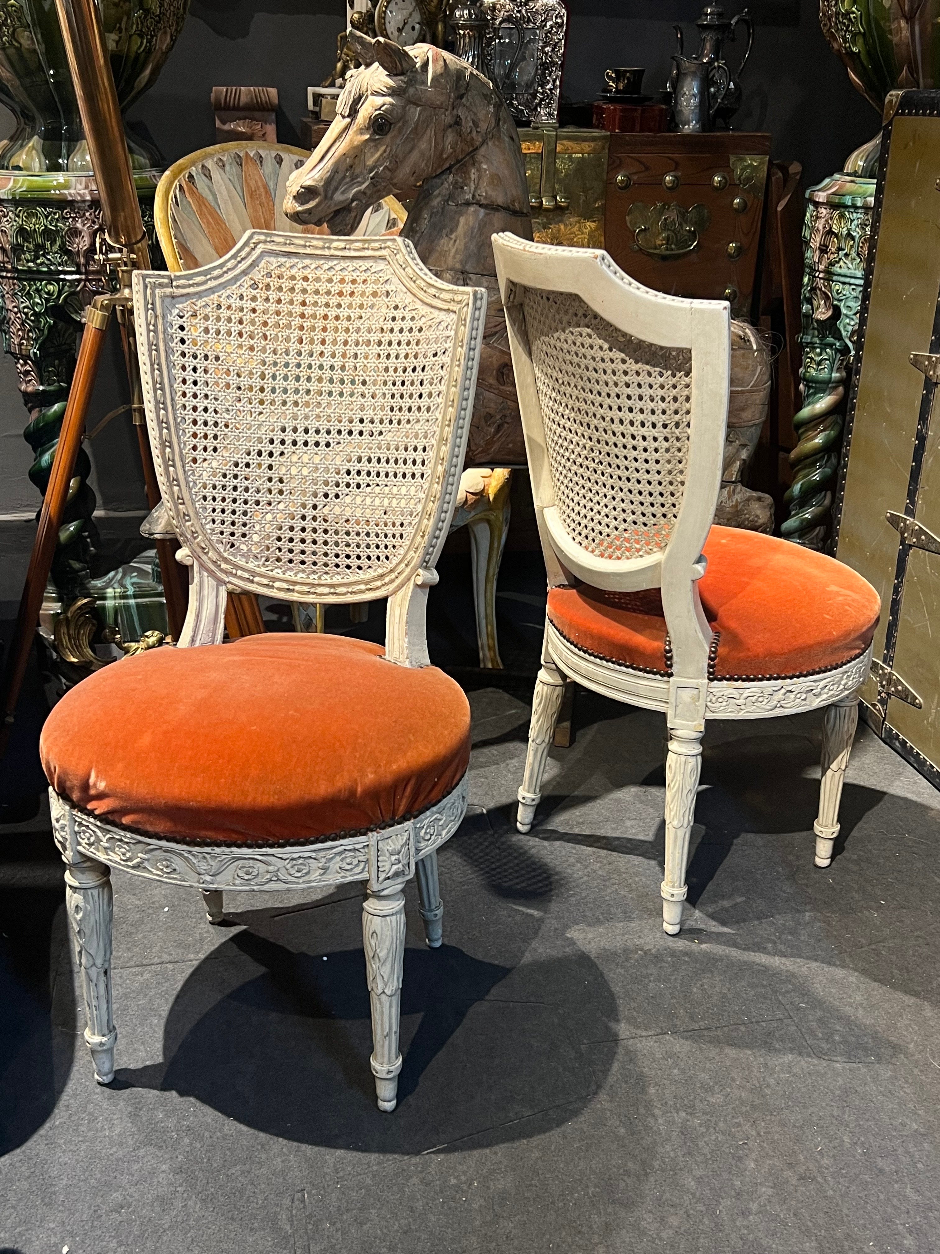18th Century French hand carved and painted in white wooden dining chair Louis XVI period with cane back. It still wearing its original upholstery in red velvet. Very good condition with no restorations but could be reupholstered. We have also a