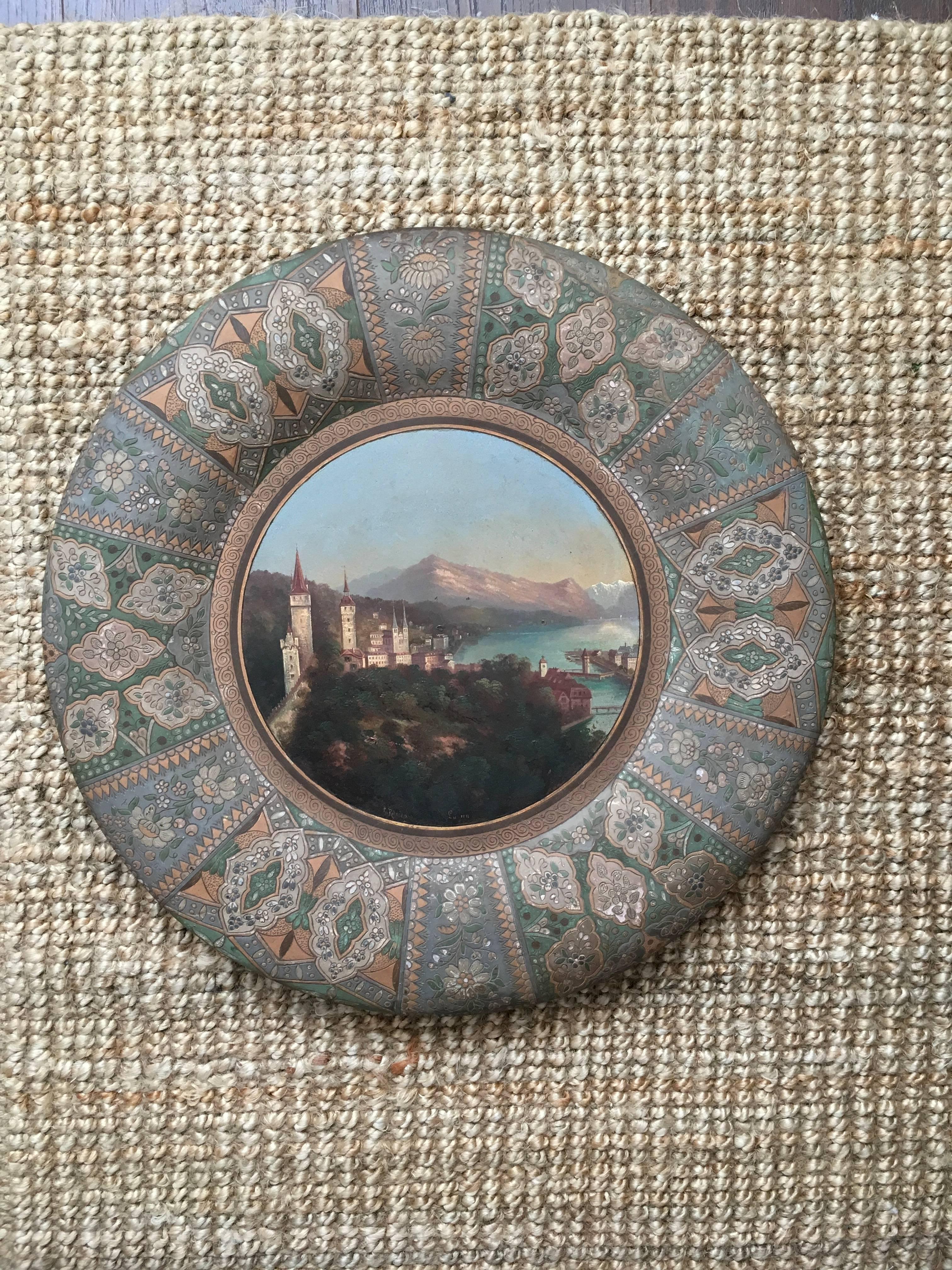 Exceptional and rare large 50 cm antique Thoune Majolika painted plaque with oil painted lake scene, dating from the 19th century. The rounded earthenware plaque has a raised rounded rim exceptionally well decorated in low relief with patterned and