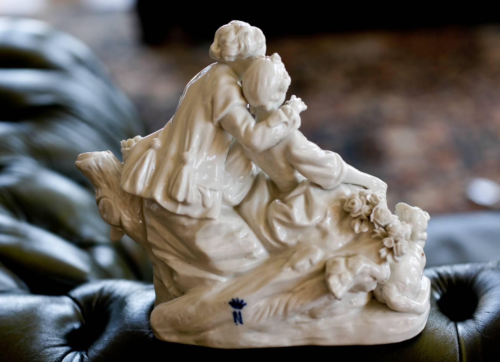 Biscuit porcelain 'Le Fluteur Boucher'
circa 1751-1755, 
Modeled after Boucher, representing a maiden seated on rockwork, in a talk with a gallant, supporting a basket of flowers, a lamb and dog at their feet.
 