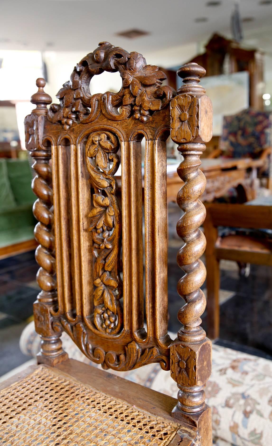 Four-carved dining chairs with beautifully decorated straight backs, twisted legs and caned seats. An acanthus leaf theme is utilized throughout the chairs.
France, circa 1830.