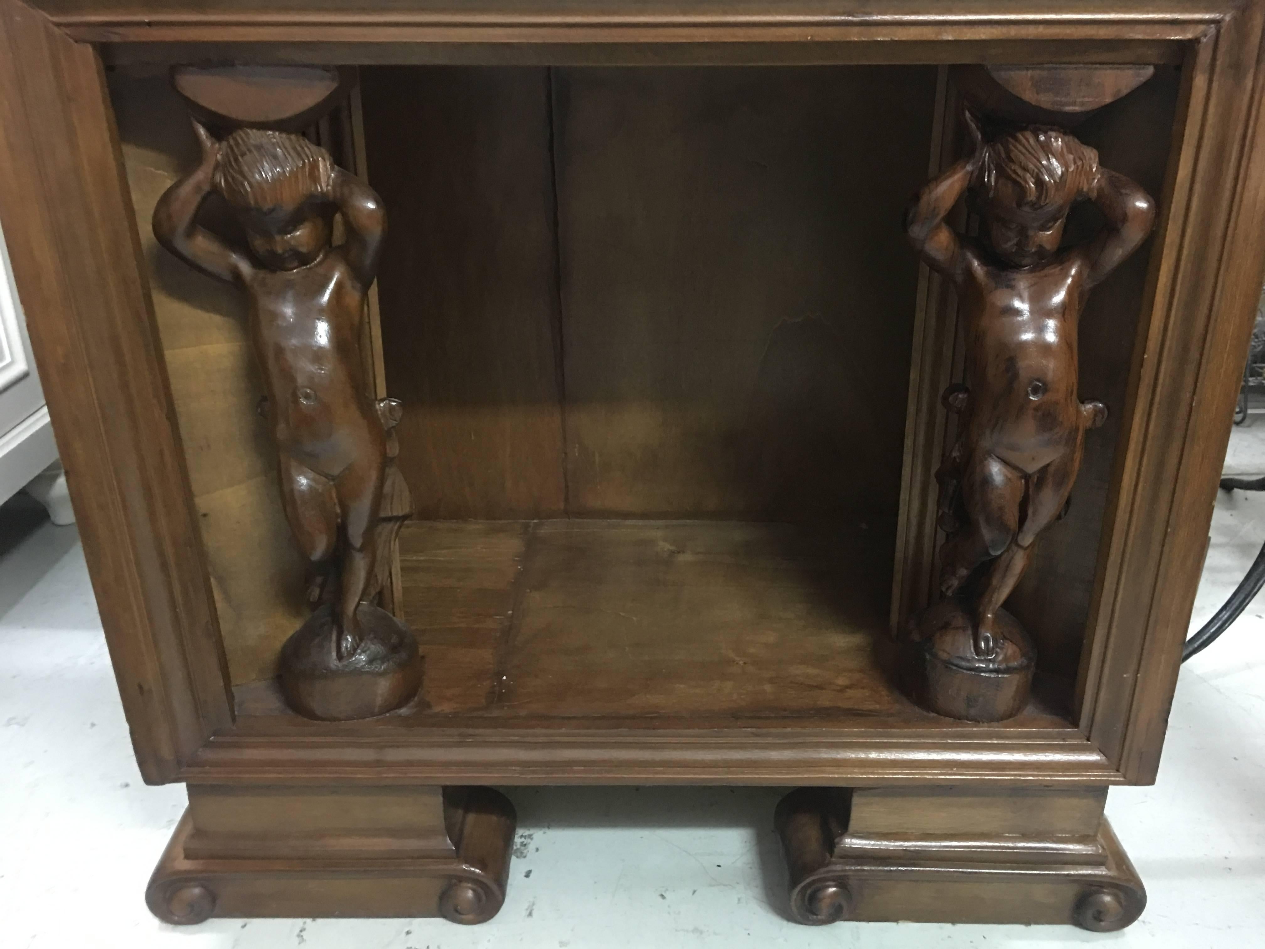 Amazing chest/table all from wood, circa 1930s with two holding carved cupids as colums.
Free complimentary shipping all around the world!