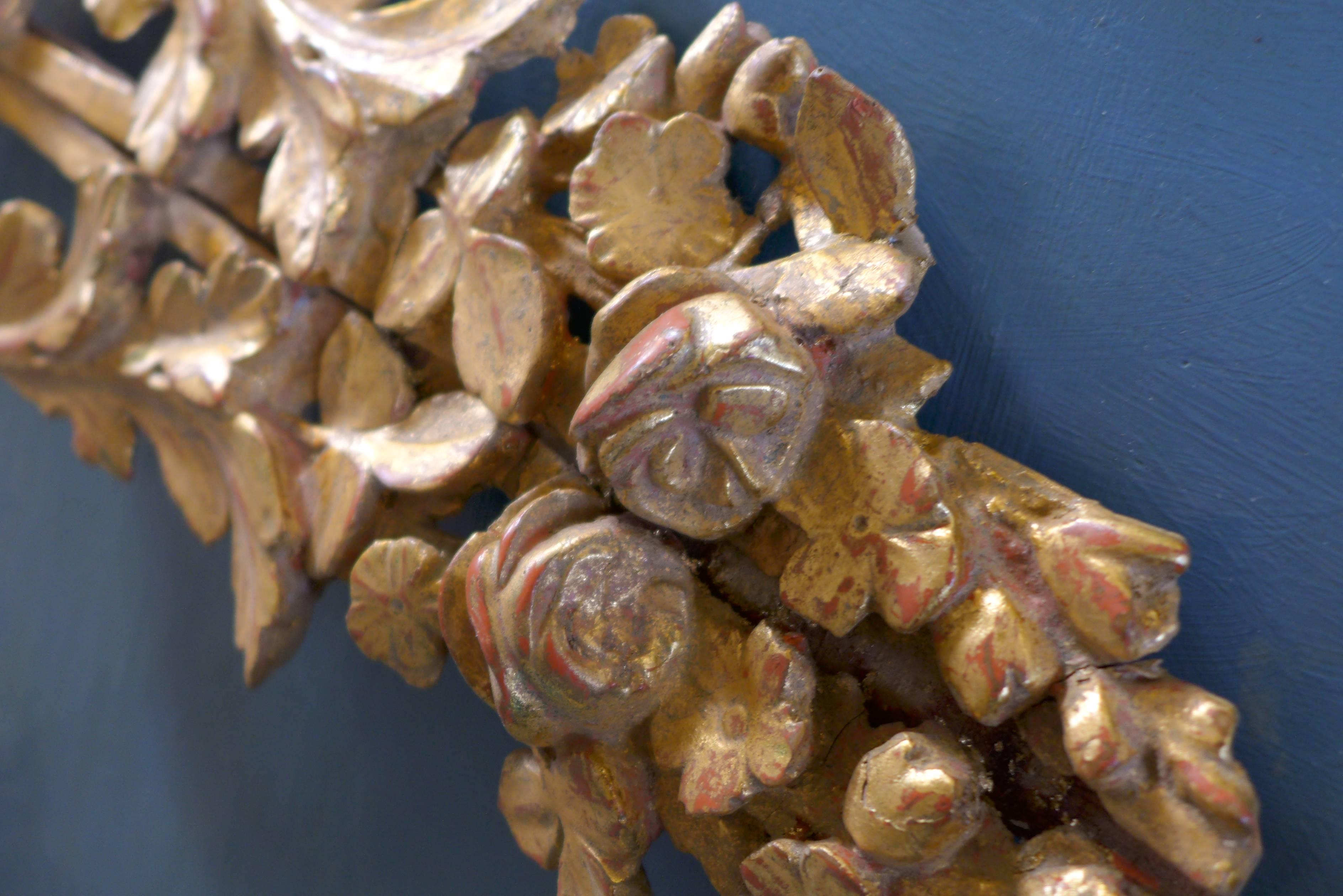 18th century handmade giltwood decorative element representing a trophy of music in an entourage of flowering branches,
France, circa 1790.