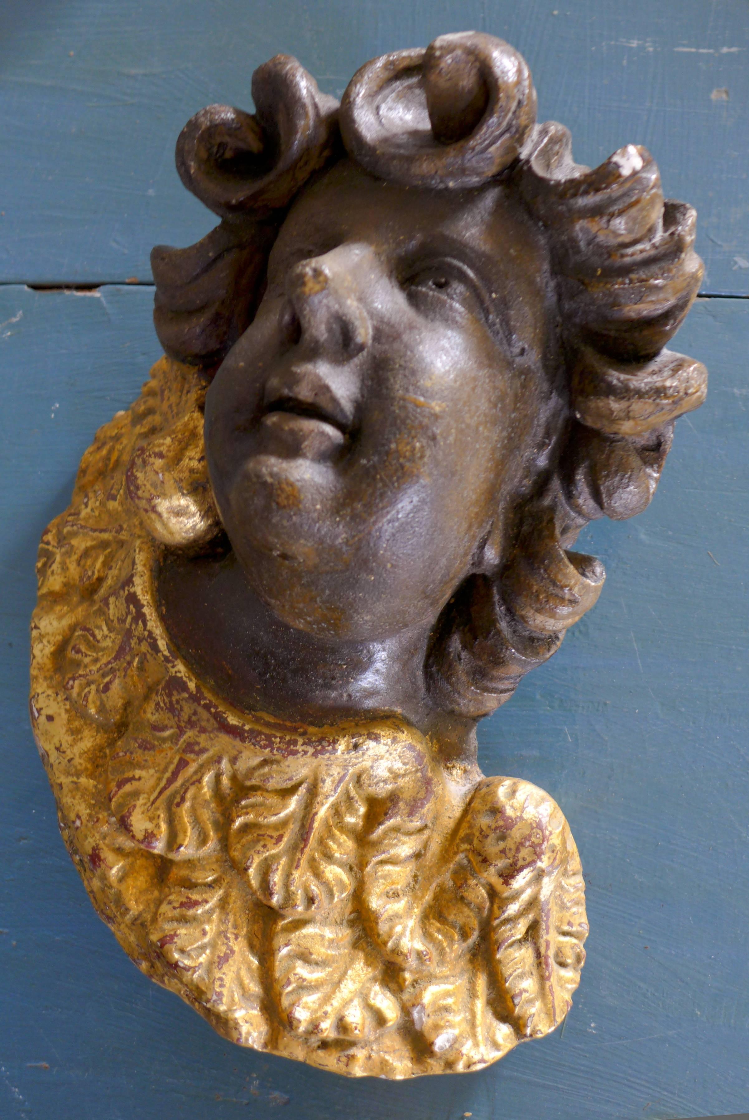 17th century wall decoration representing an angel's face made of white ceramic hand-painted in black with beautiful golden collar,
France.