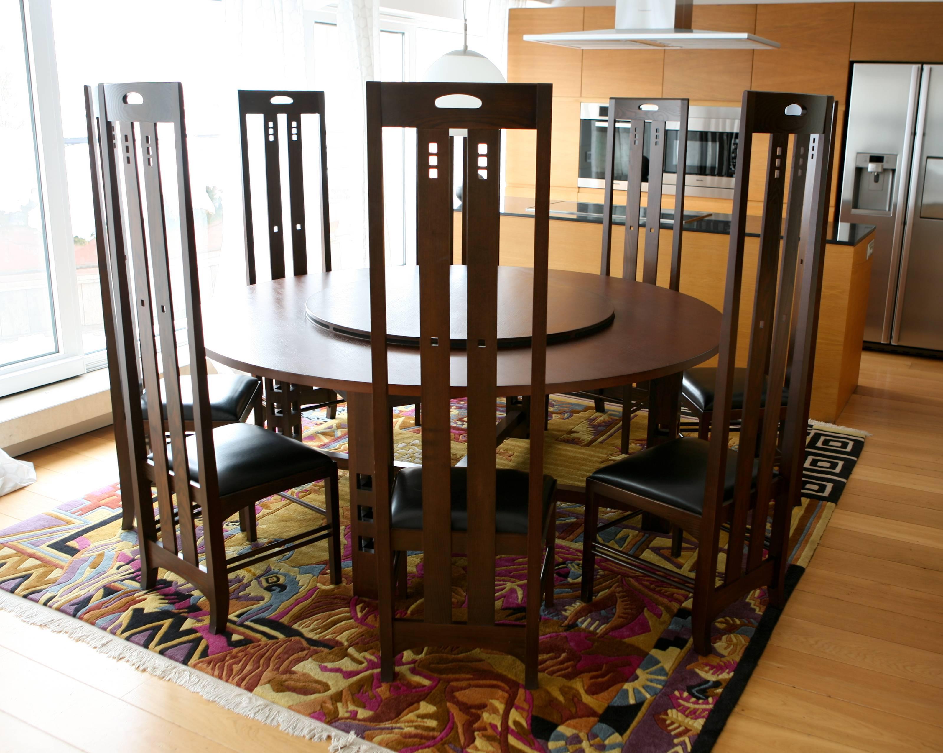 Art Nouveau style set of circle dining table and eight high back chairs, by Macintosh.
There is a mechanism for lifting the central part of the table.
All set is made of high quality wood in dark brown and the seats to the chairs are in black