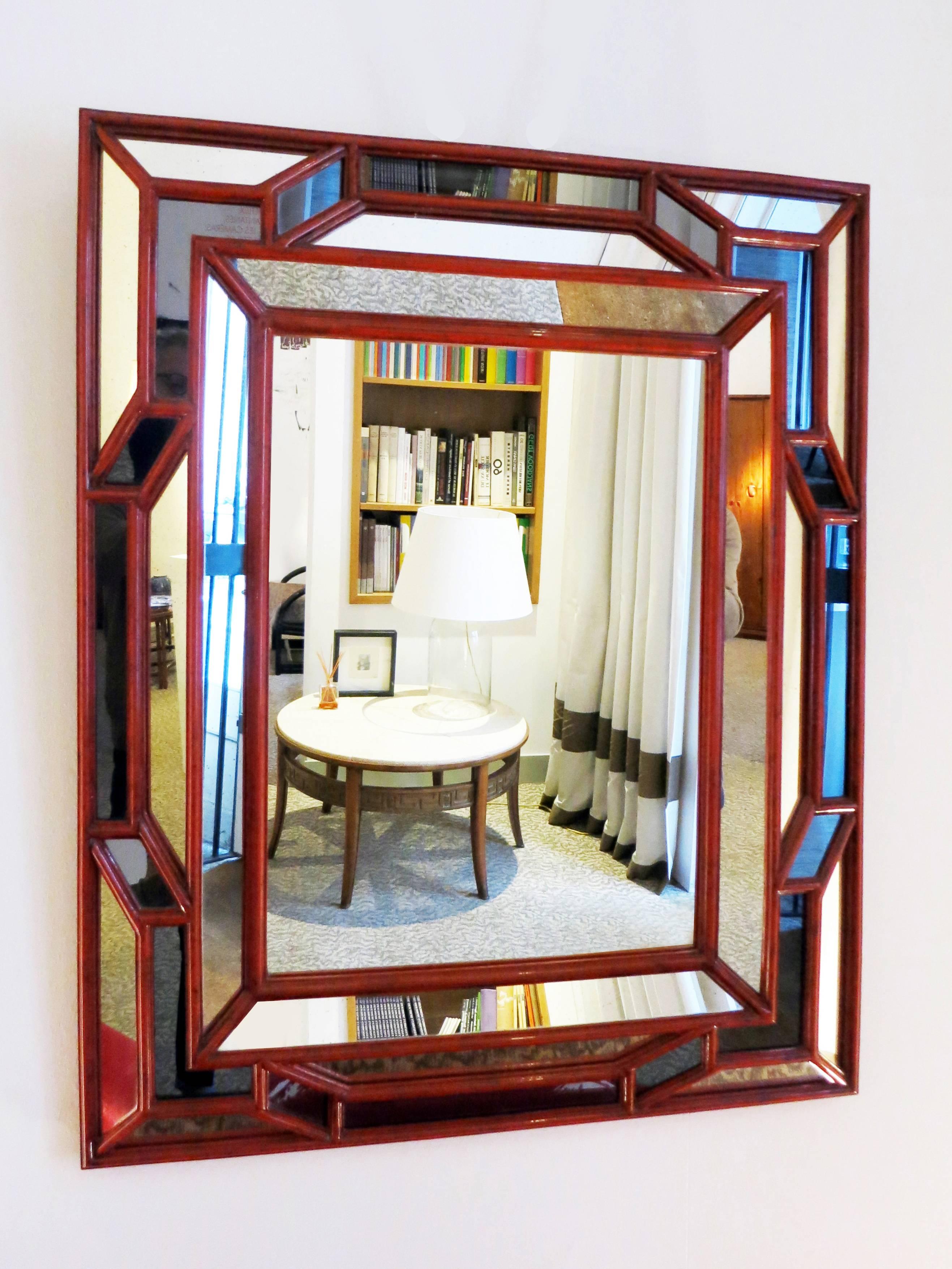 Spectacular faceted mirror from Galerie Maison et Jardin, circa 1970.
Grey and colorless pieces of mirror between Hermes red lacquered wood molded sticks.
Designed in 17th century style.
Perfect condition.