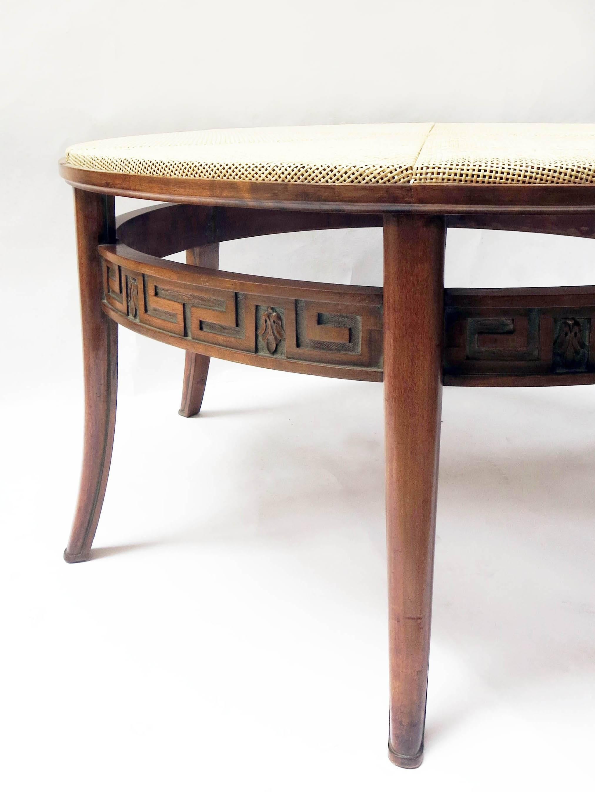 Amazing round coffee table from Sweden, circa 1940.
In patinated solid elm with a beautiful carved belt.
The top is made in sunburst cane panels.