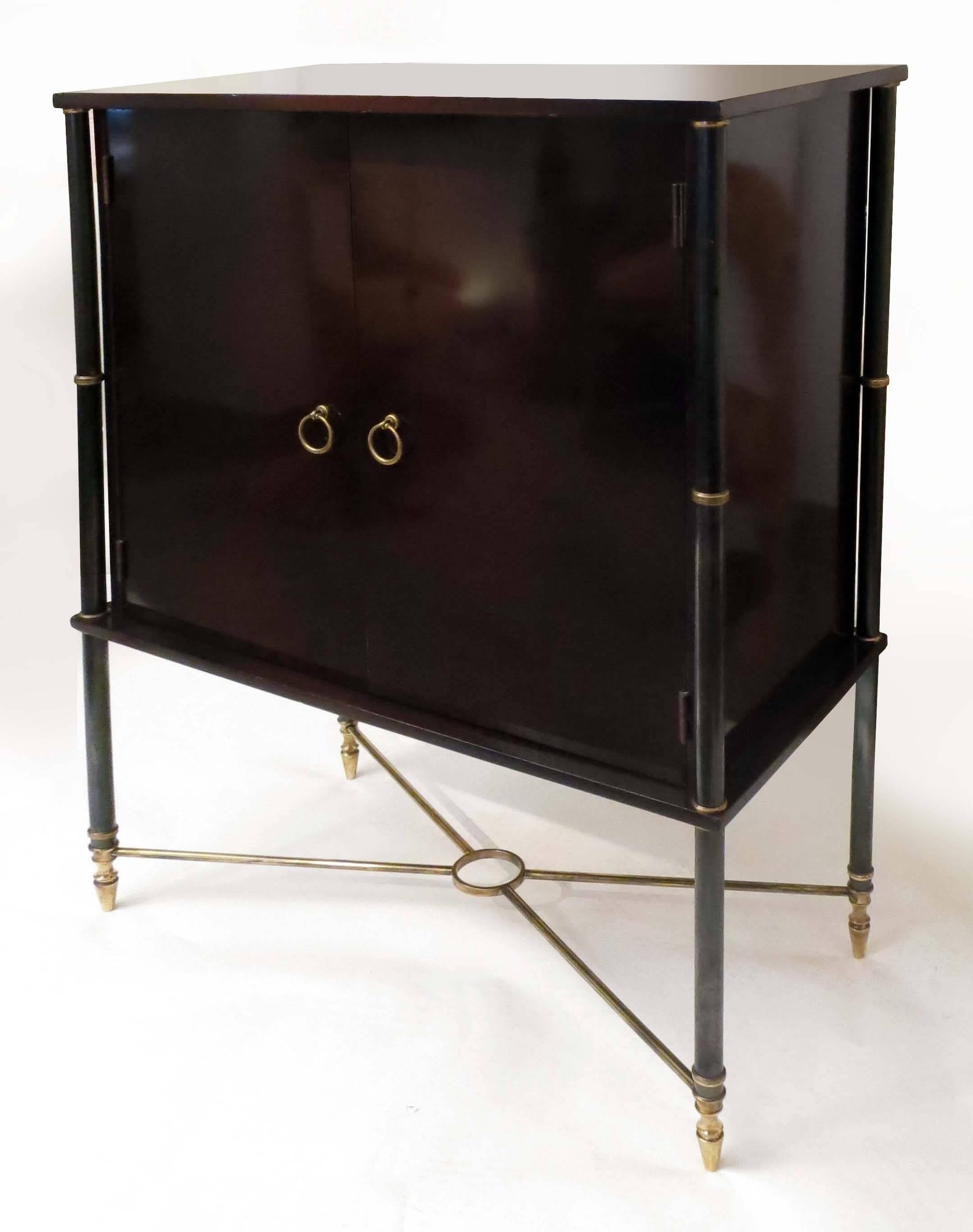 Elegant cabinet in eggplant color lacquered wood with gunmetal and brass columns at four angles.
Inside in mahogany.