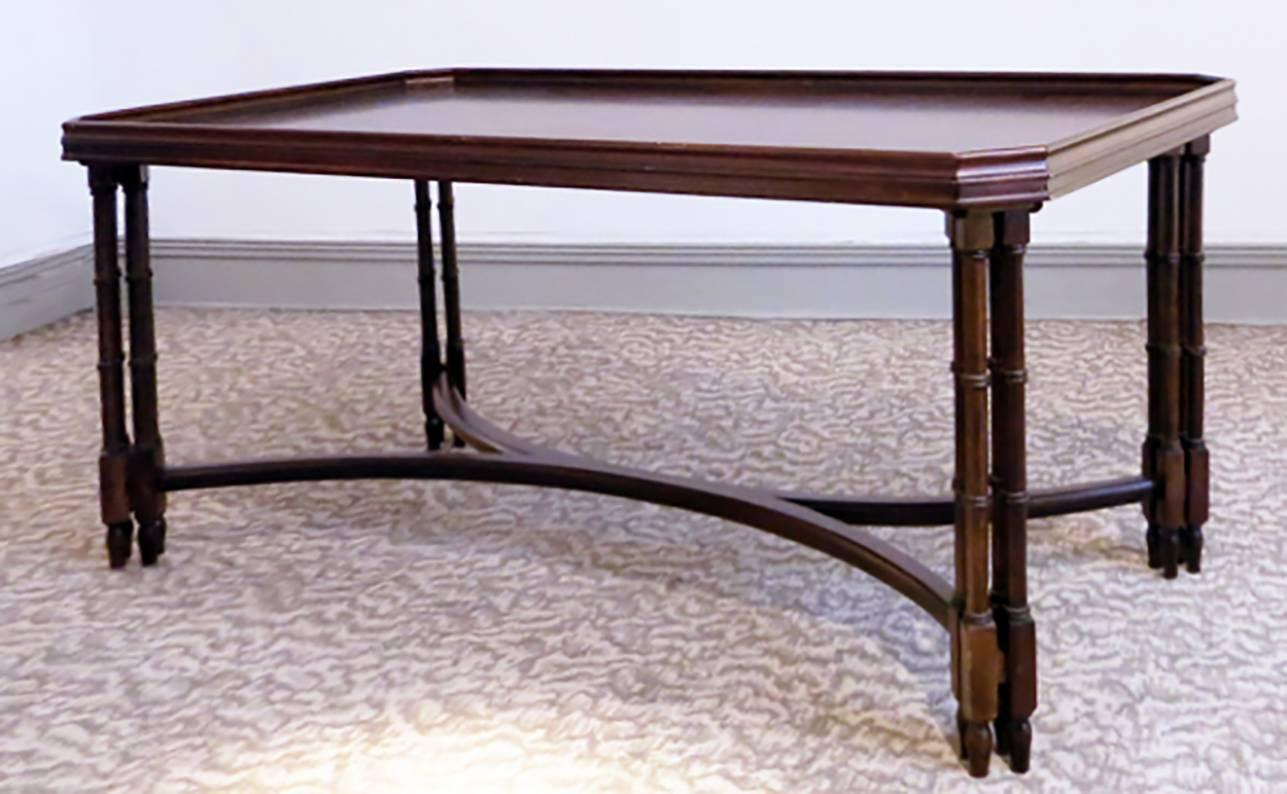 Coffee table by Madeleine Castaing from the 1950s.
False bamboo legs in solid mahogany.
Beautiful mahogany varnished top.