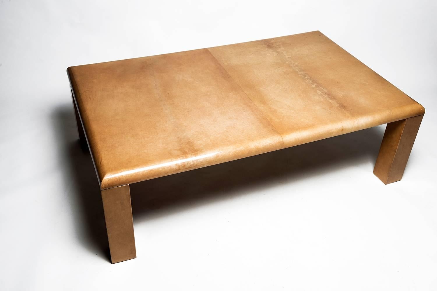 Aldo Tura's signature combination of rich materials and artisanal mastery is elegantly expressed in this fine coffee table. Lacquered goatskin covers the clean lines of the wooden base. 
Mid-Century Italian glamour in excellent condition. Labelled.