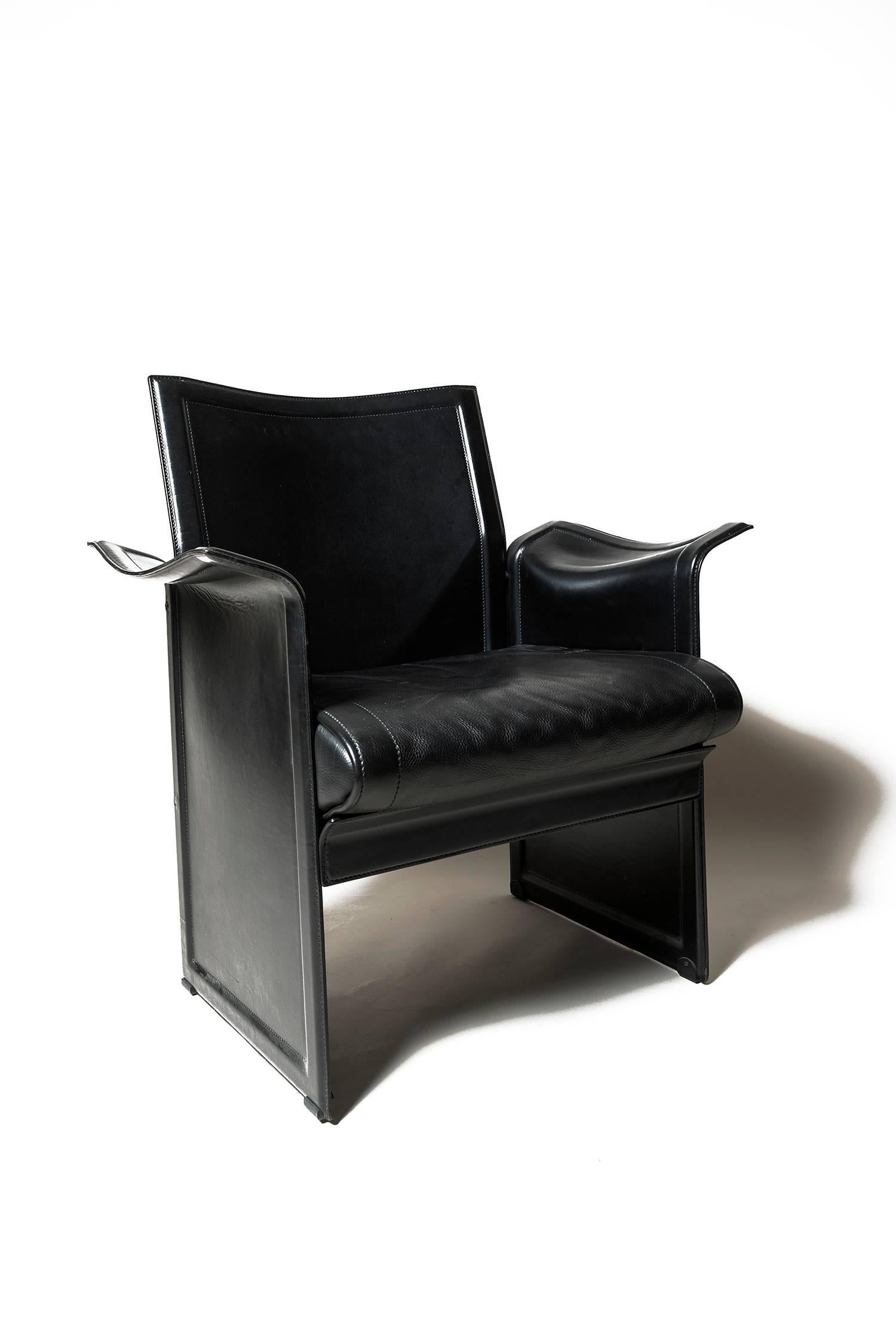 Set of four leather armchairs, in black. These 'Korium' chairs were designed by Tito Agnoli for Matteo Grassi. 
Very comfortable, in great condition from a private residence.
