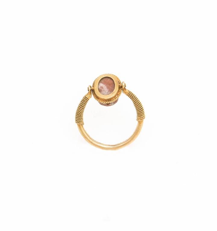 This delicate finger ring is wearable and remains in an excellent state of preservation.
The fine gold ring has an ancient swivelling scarab, drilled lengthwise from two sides.
Provenance: Private English collection.
Accompanied by a certificate of