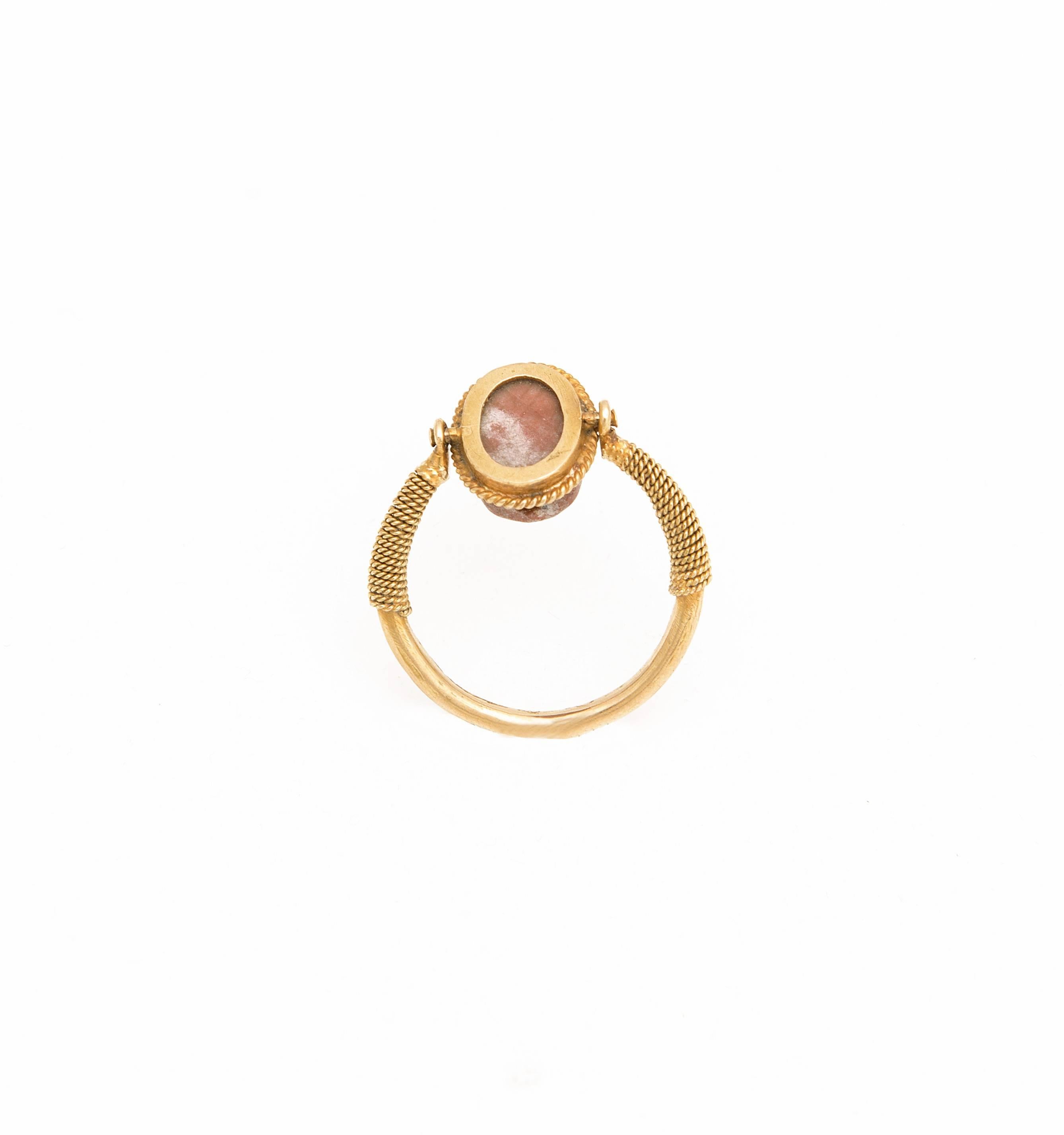 This delicate finger ring is wearable and remains in an excellent state of preservation.
The fine gold ring has an ancient swivelling scarab, drilled lengthwise from two sides.
Provenance: Private English collection.
Accompanied by a certificate of