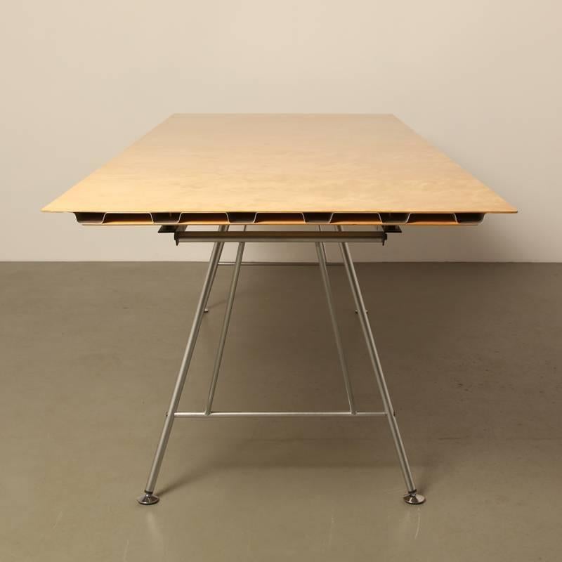 Very light weight table, originally designed as a desk. You can adjust the height in increments up to 75 cm; the legs are also easily removed so that in storage it takes up very little space.

With its aluminium corrugated profile it seems