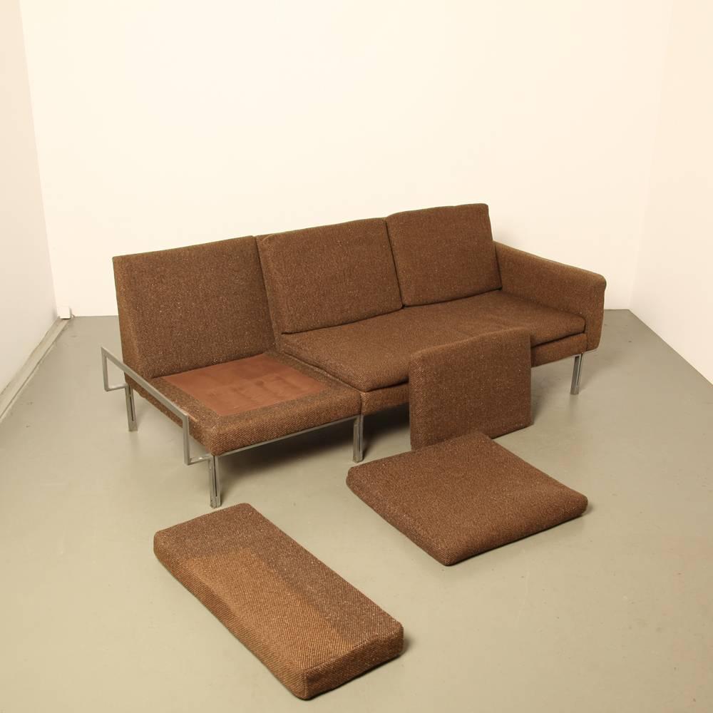 It might be real or it might be in the style of.

Brown woven wool

This can be completely disassembled, you could reassemble it as a two-seat.

Name: Parallel Bar Sofa
Designer: Florence Knoll
manufacturer: Knoll International
design year: