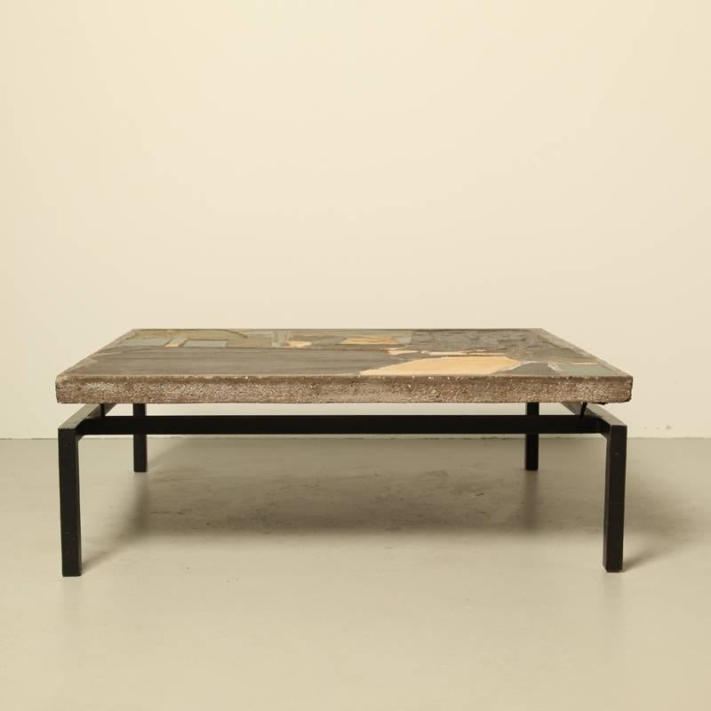 A concrete coffee table of Paul Kingma 1960, a Brutalist.
It is an early edition,
is signed with his hand, date and name written in concrete,
Beautifull nature colored stones ( his daughter told us they collected stones every holliday in France