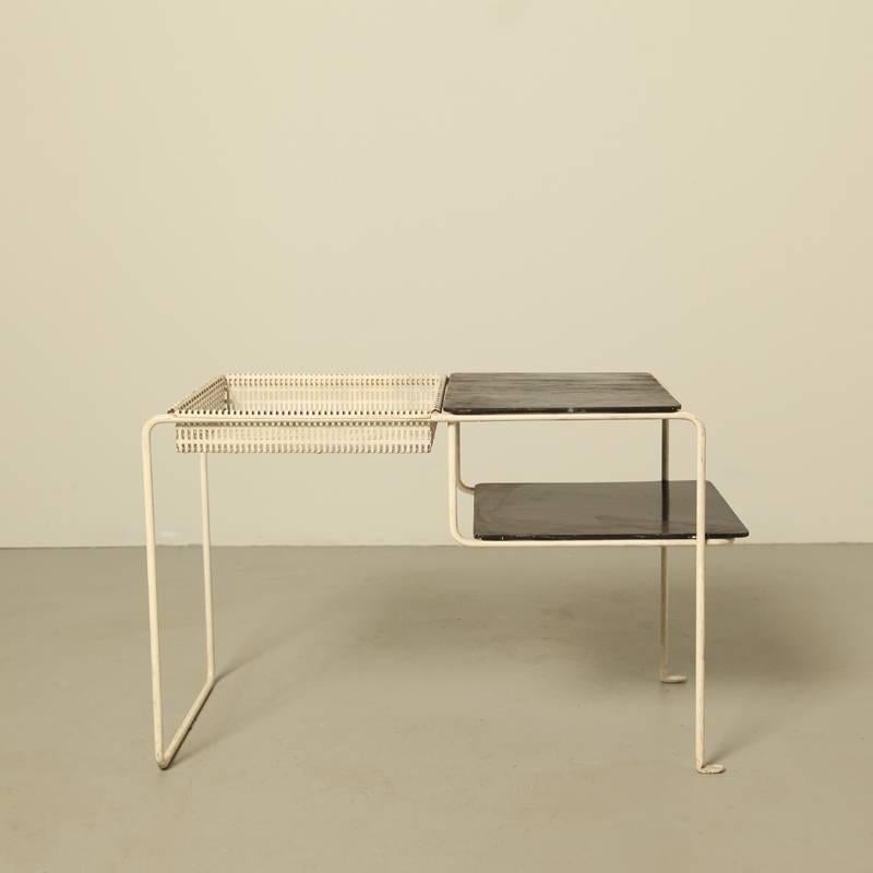 This “Groesbeek” side table with magazine rack was designed in 1956
by Elmar Berkovich for the Dutch manufacturer spectrum.
It was only in production for two years, 1956-1958
and very few were manufactured.
White sprayed steel, white perforated