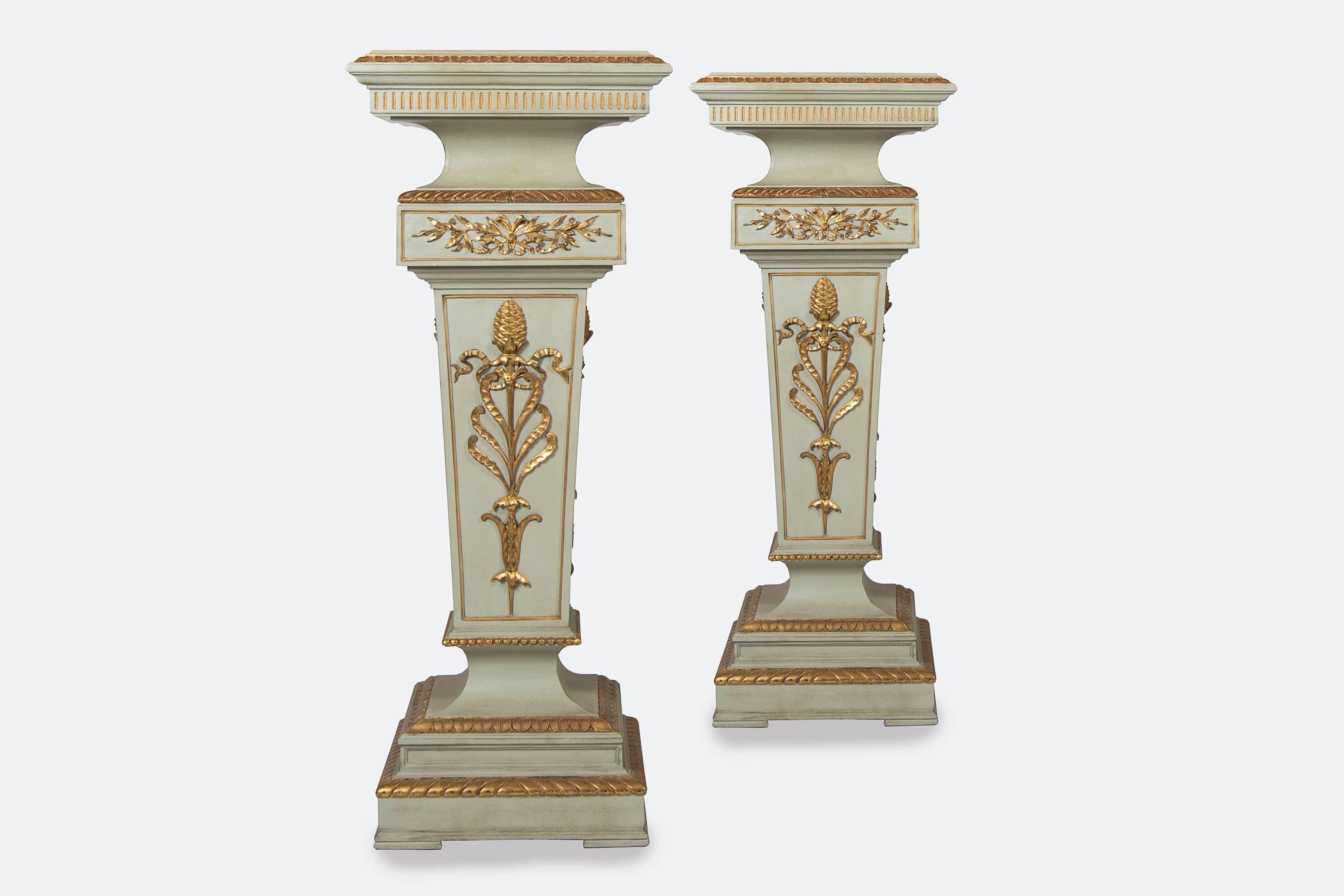 Pair of painted wood steles, white and gold colours.