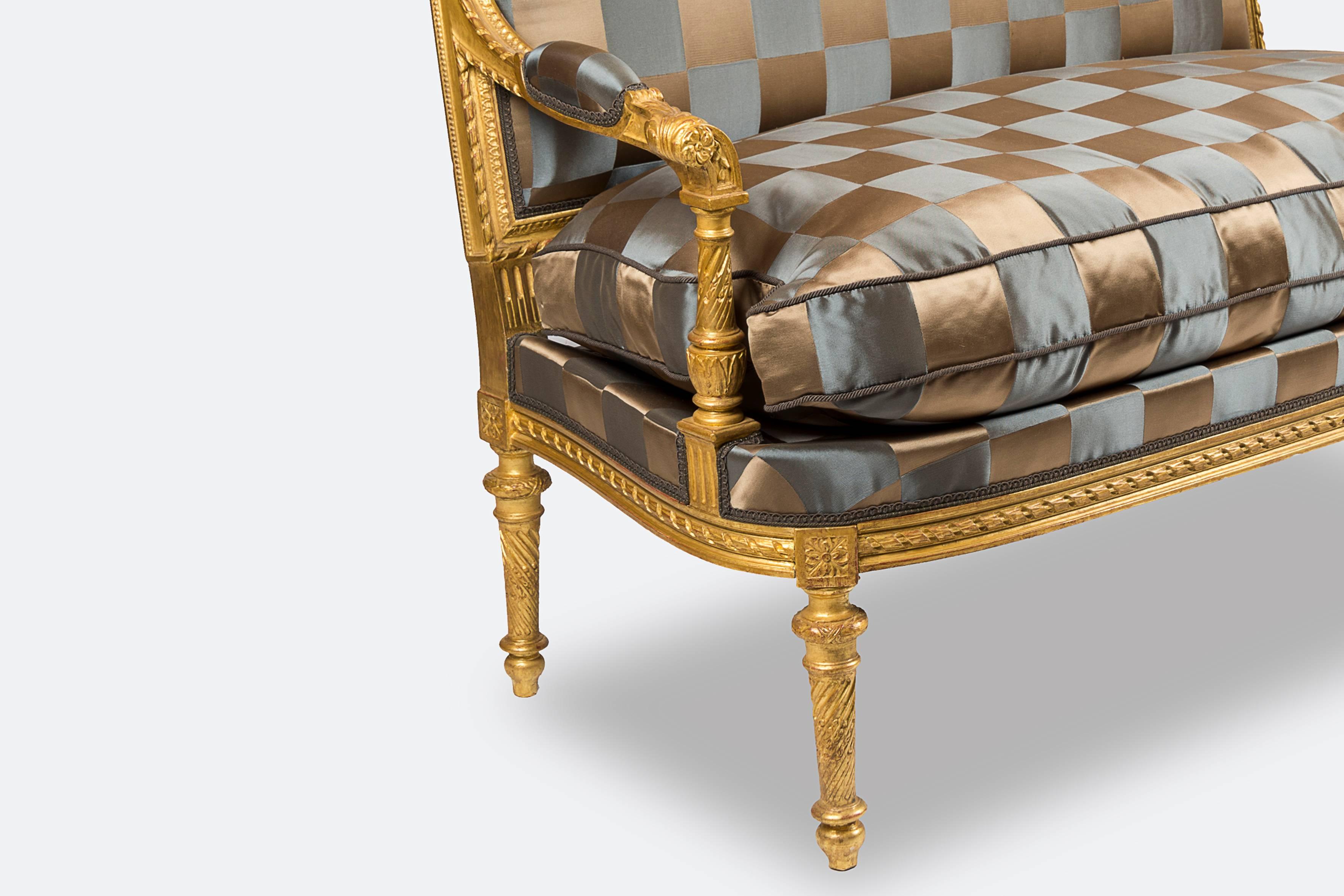 Style Louis XVI giltwood two-seat sofa, upholstered with Rubelli fabric.