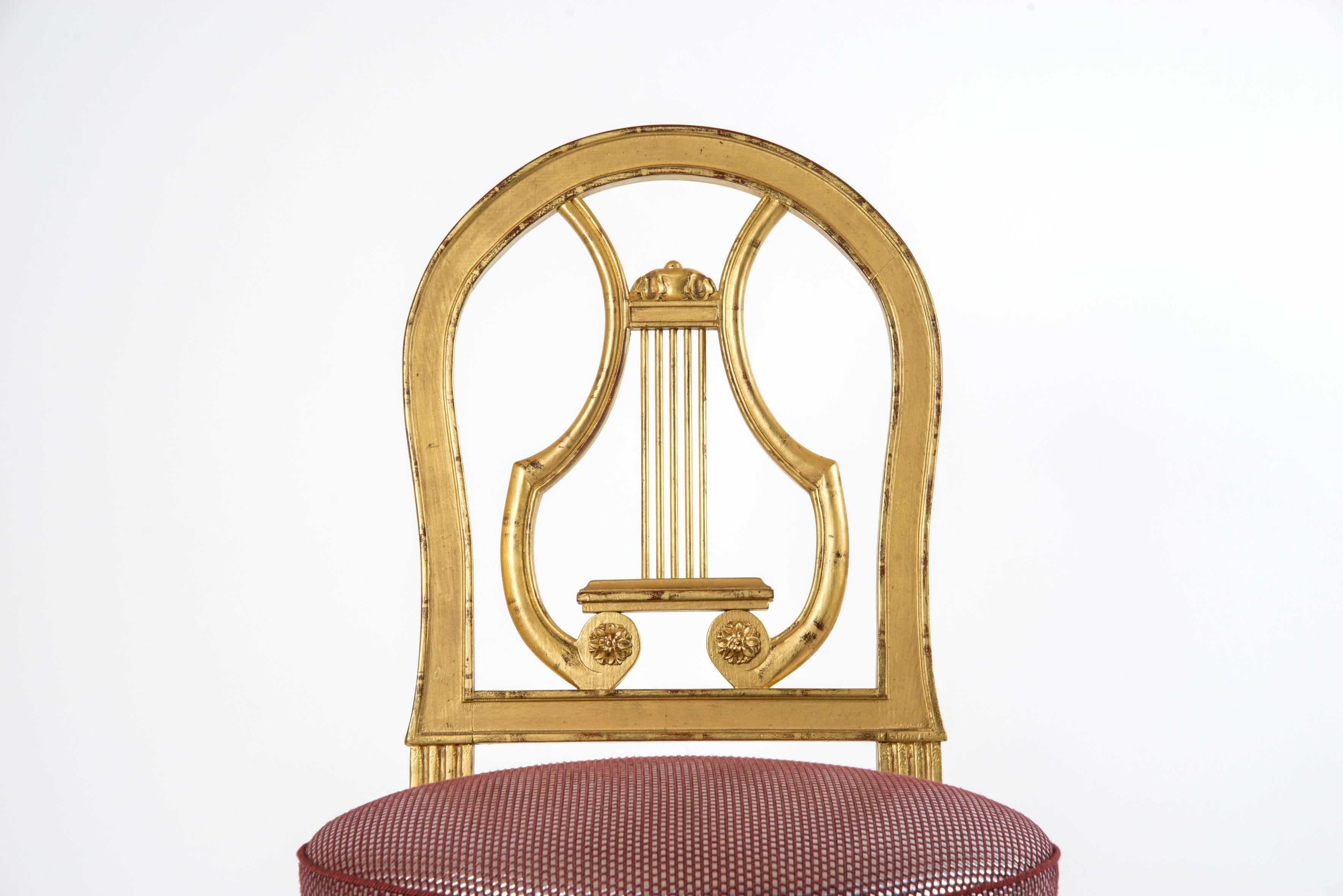 Set of eight style Louis XVI giltwood chairs, back in lyre shape and round seat.