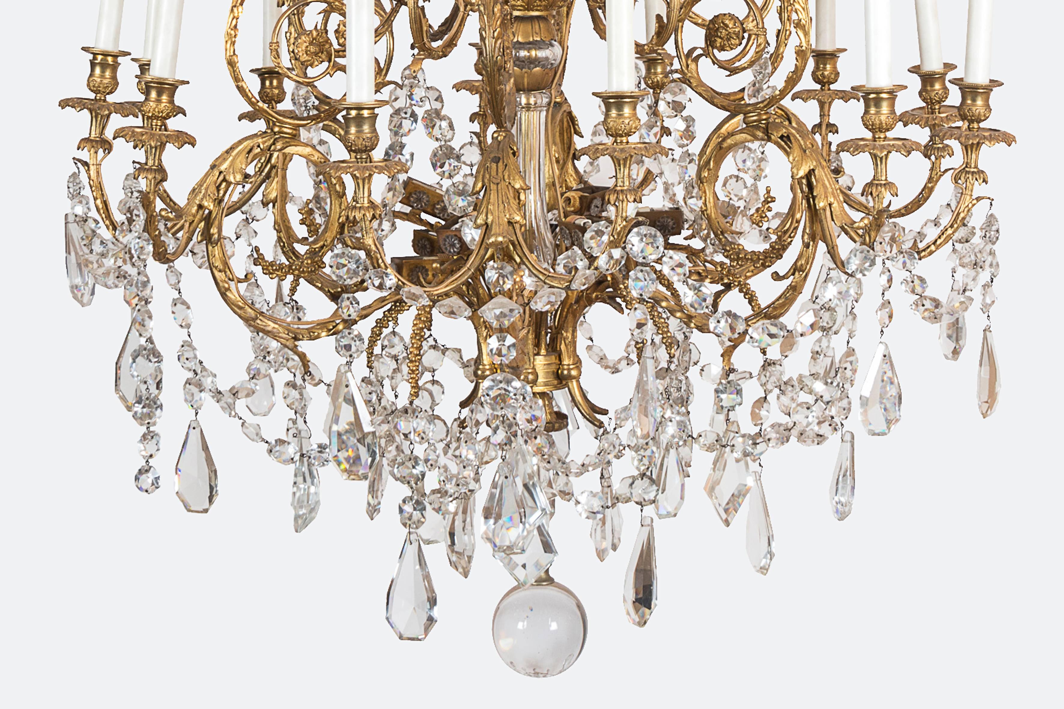 Gilt bronze and crystal chandelier, indirect lighting, drops and crystal flowers.