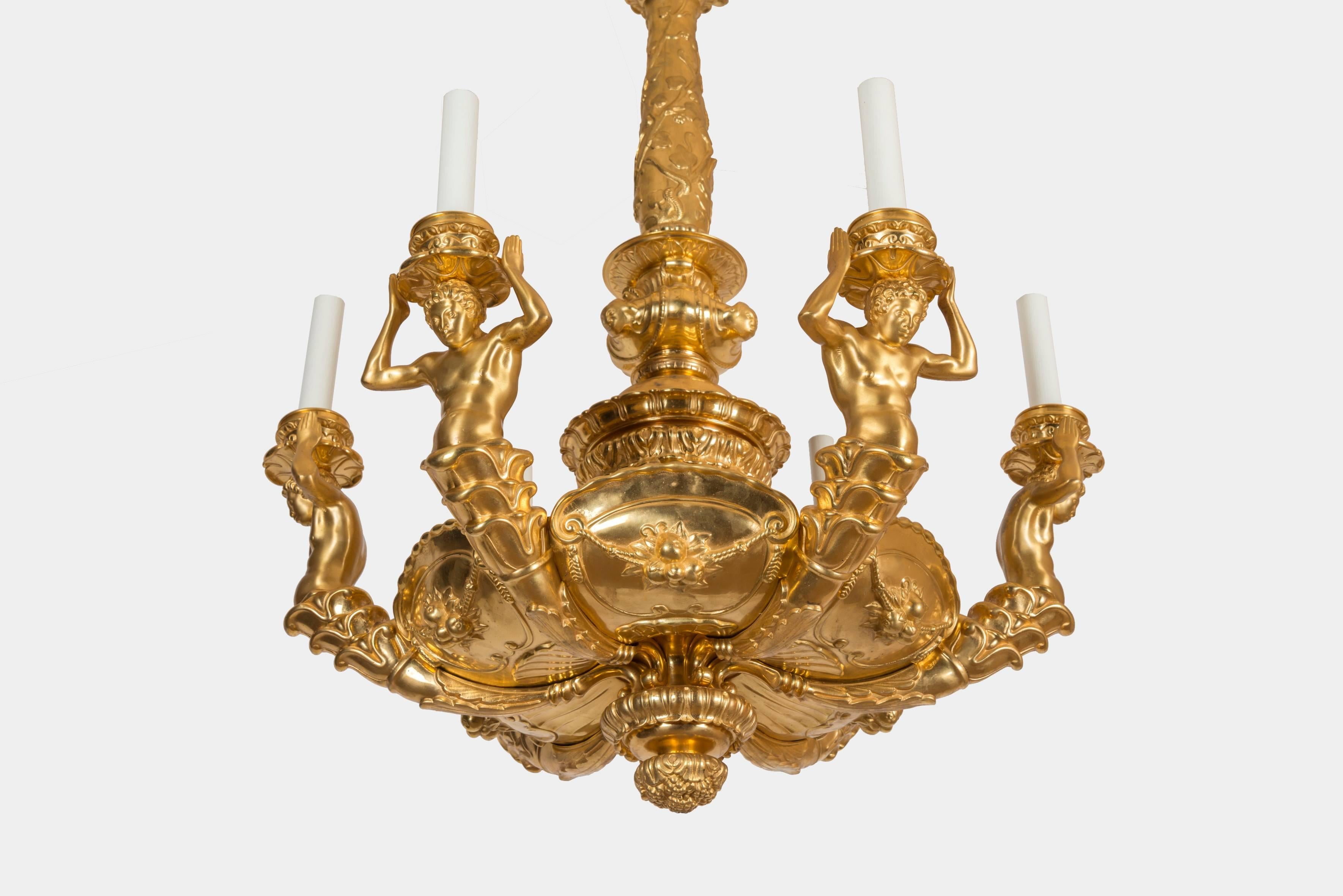 Gilt bronze chandelier with six lights supported at arm's length by sculpted men.
