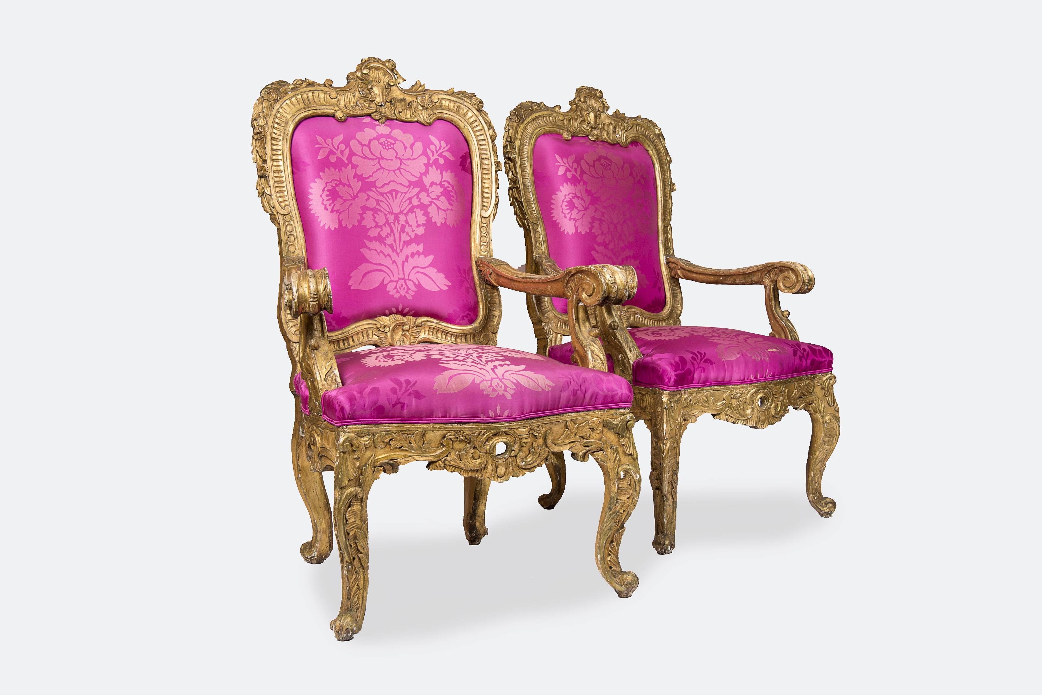 Pair of Italian giltwood Baroque "Royal" armchairs, upholstered with a fuchsia colored silky fabric.