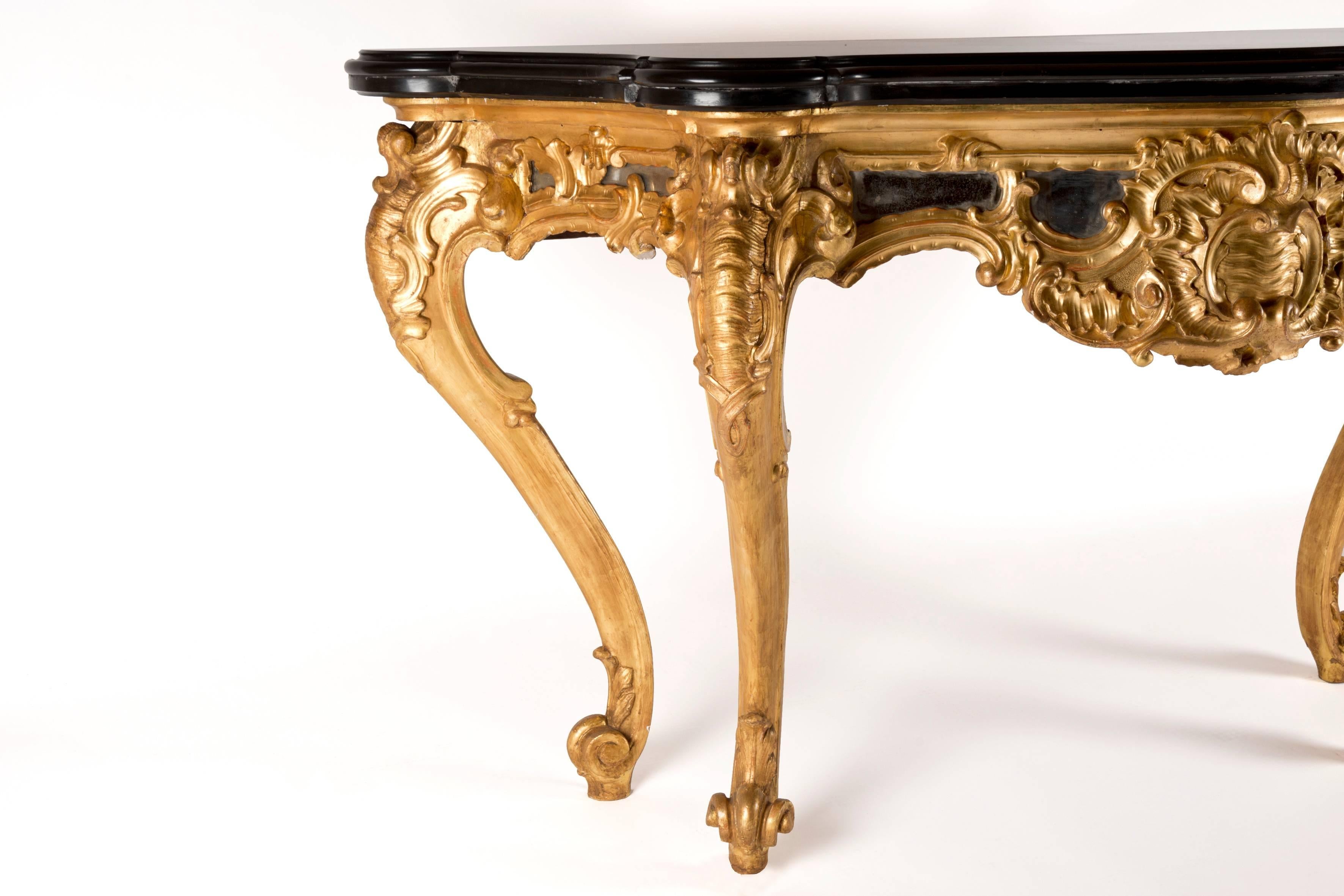 Pair of Italian consoles in giltwood and mirror inlaid consoles, top black marble.