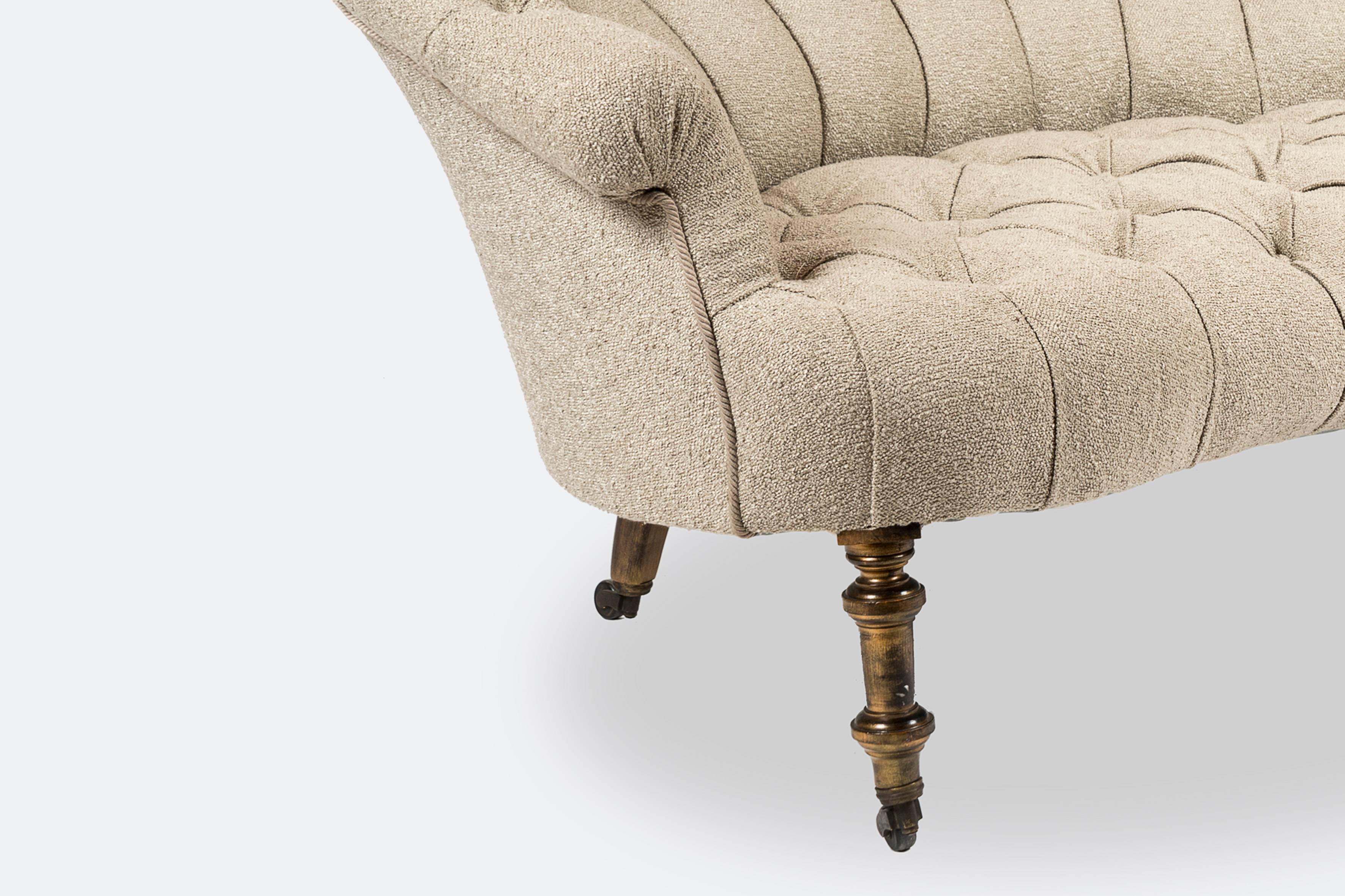 Pair of elegant Napoleon III padded sofas, legs ending with castors, beige fabric.