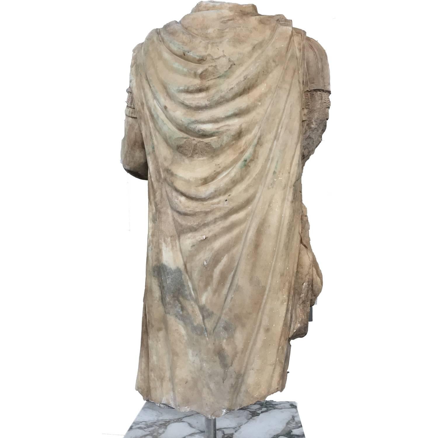 Stunning classical statue of Emperor Hadrian, headless, made as a torso as a replica as from the Archeological style. This torso is a portrait of the emperor Hadrian with his armor and is aged to give the same soul and character of an ancient one