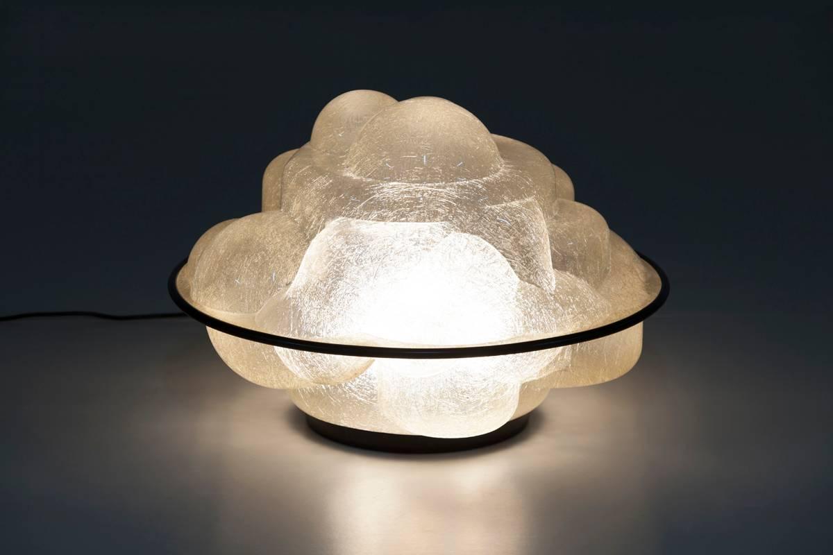 Table lamp radiating diffused light. An interpretation of the famous Italian dessert. Manufactured in fibreglass with black rubber ring. Light source: Three incandescent E27 bulbs.