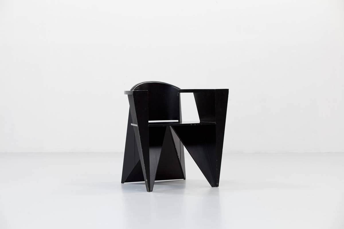 Postmodern black lacquered wood armchair in a cubist style. Depending on the points of view the chair takes different aspects, combining lightness and strength.

  