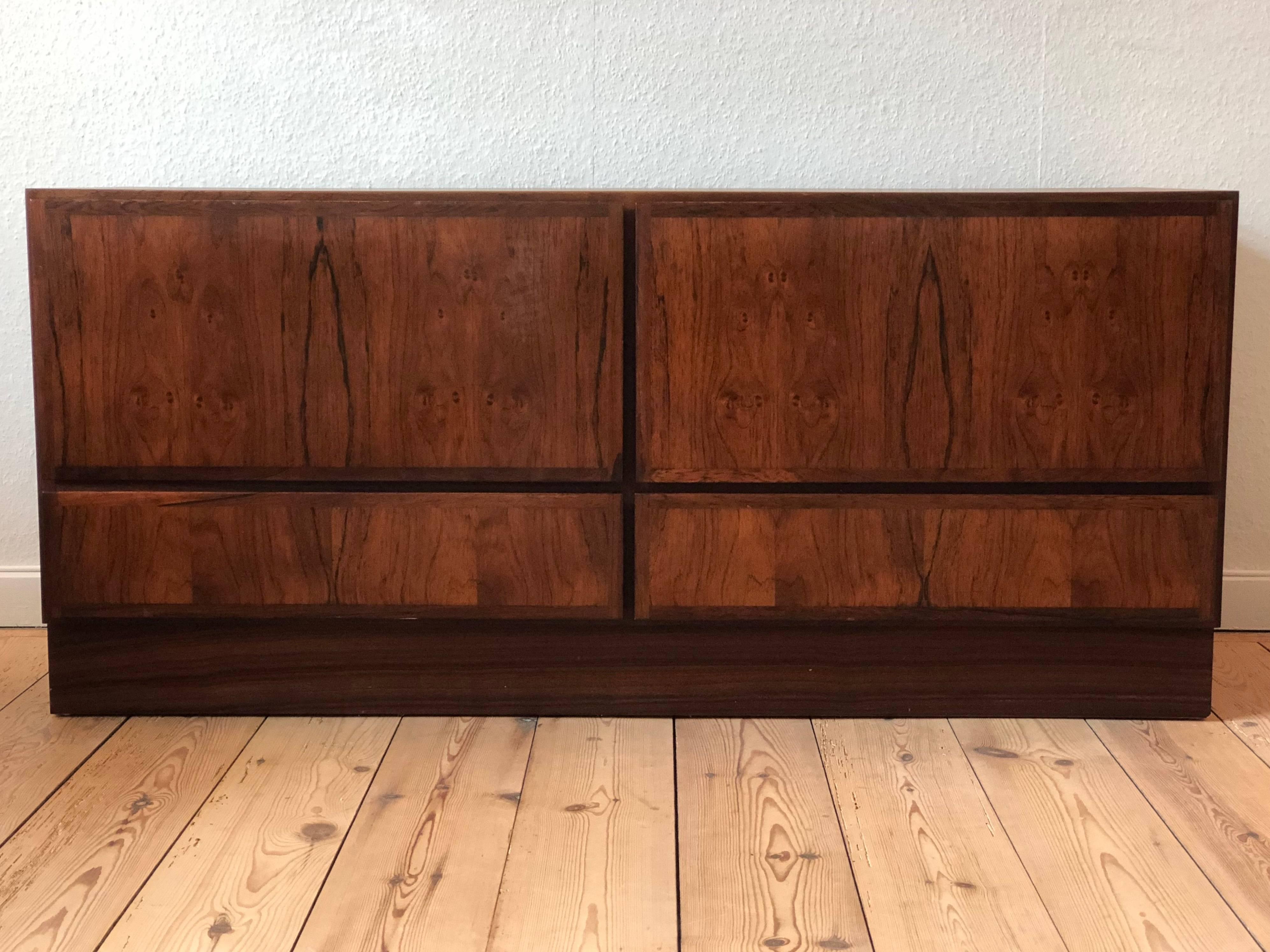 Rosewood cabinet from Gunni Omann Møbelfabrik. Features four drawers with bevelled edges, the top two have an ingenious secret locking device accessible from the bottom drawers. There are also plenty of access for cables via the real of the top two