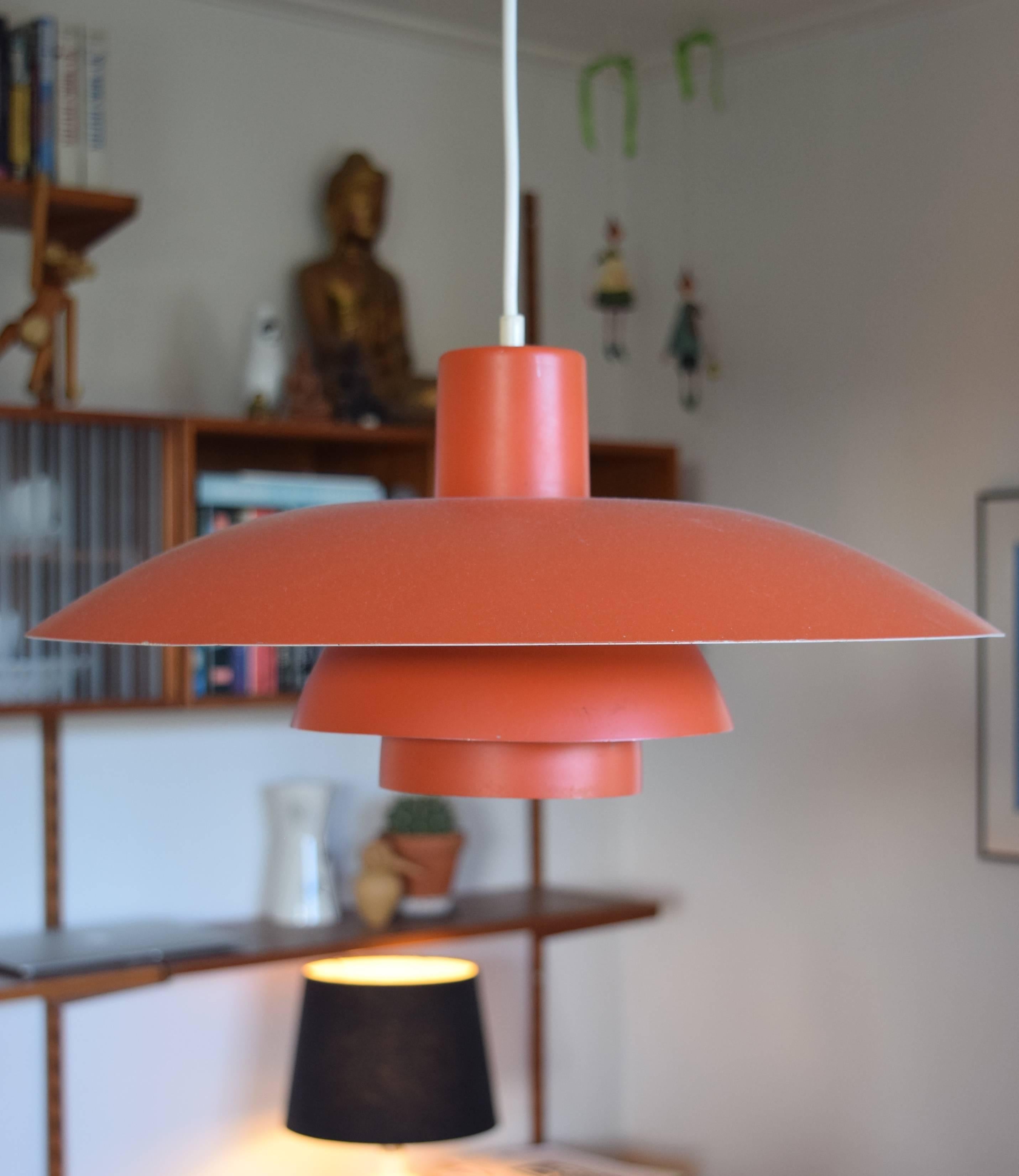 Iconic PH4 lamp designed by Poul Henningsen for Louis Poulsen. Original red finish. This is an earlier model and dates from the 1960s. Apart from a few small surface marks the lamp is in a very good vintage condition.