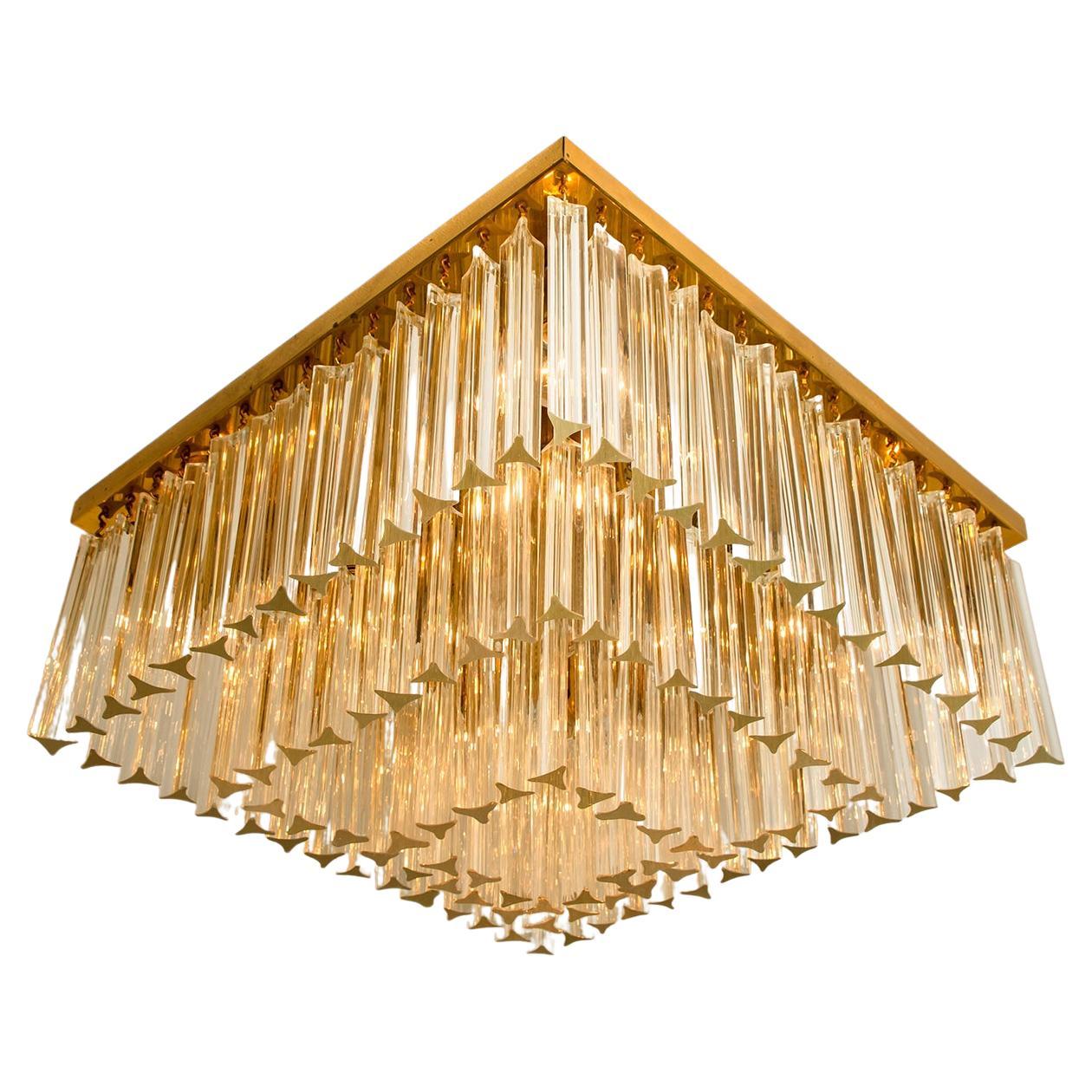 1 of the 3 stylish three-tiered faceted Murano flushmount with several clear crystal glass prisms was designed and produced by Venini in Italy from the 1970s. The Venin Murano prisms are suspended on a square gold plated frame. The prisms sparkle